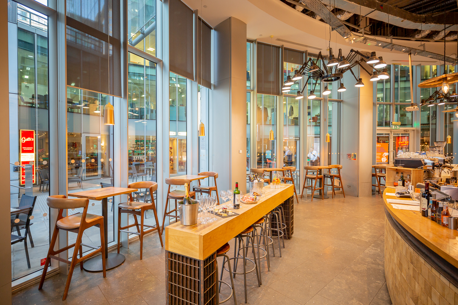 Modern open-concept venue with large windows for networking events and casual meetings.