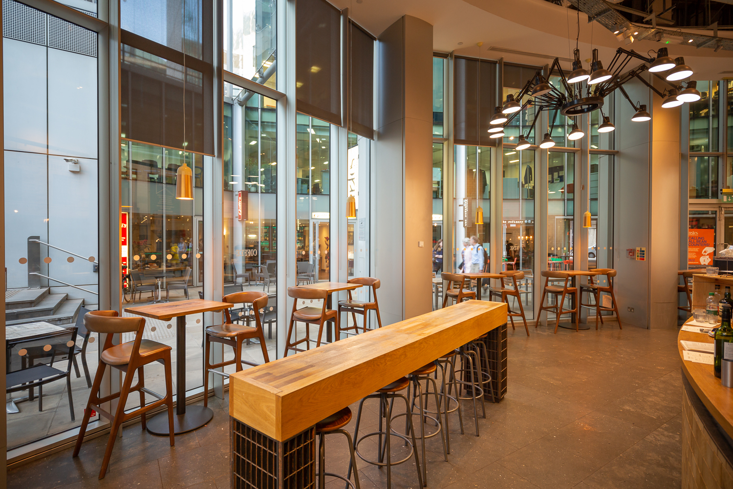 Modern open-concept venue with high-top tables for networking events in Moorgate.