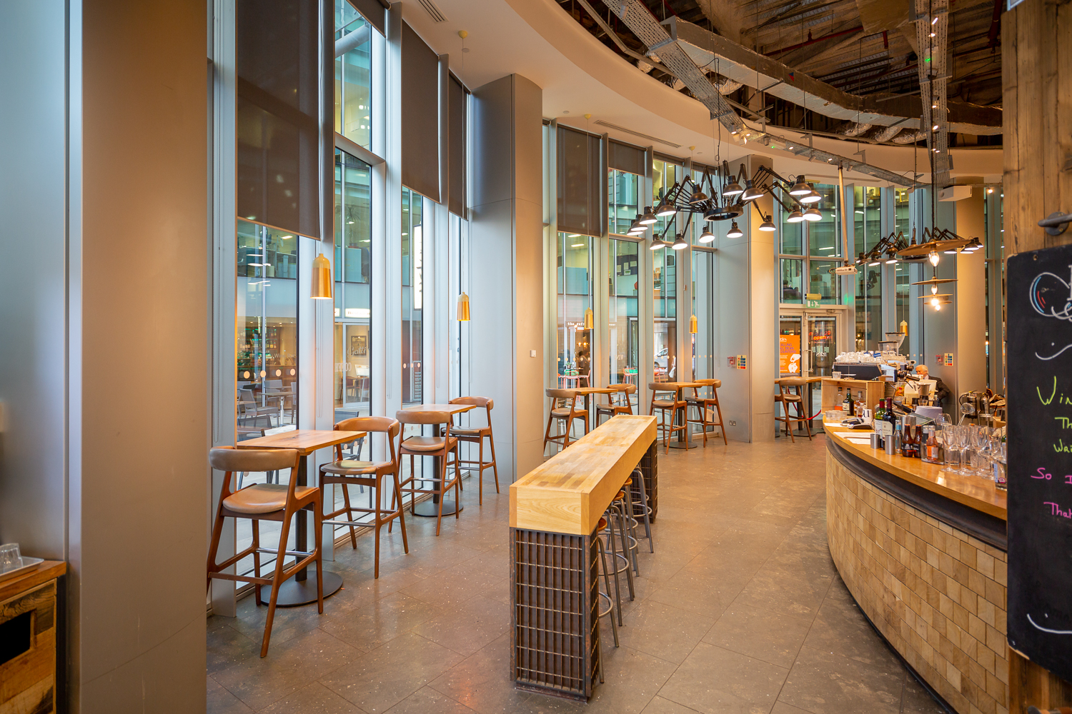 Modern open-concept venue with large windows for networking events and meetings.