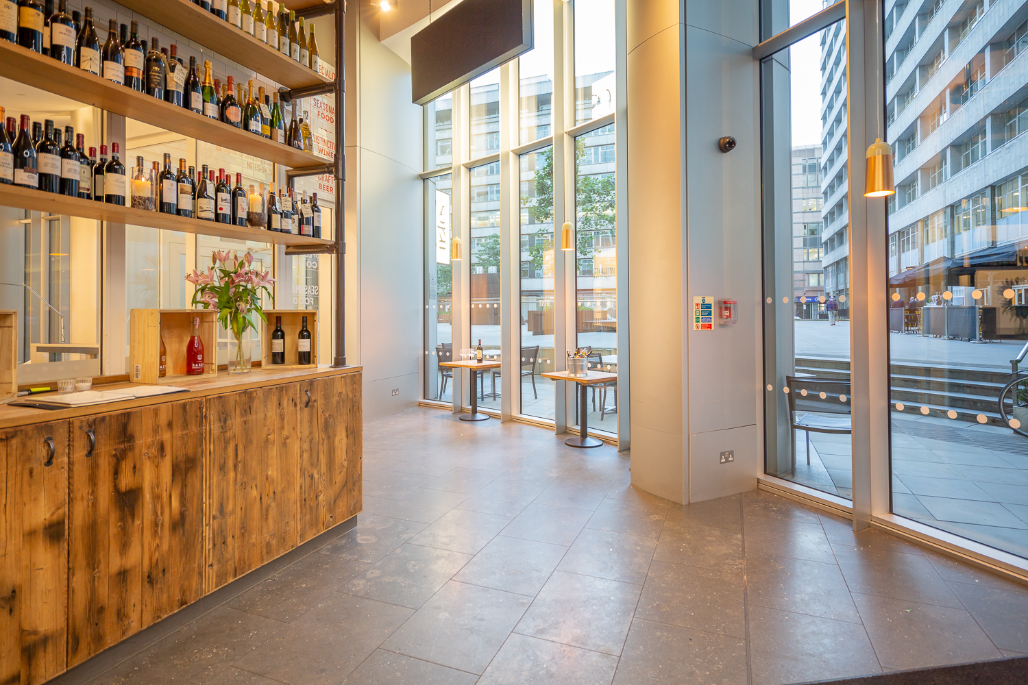 Modern venue with stylish bar and wine display, perfect for networking events.