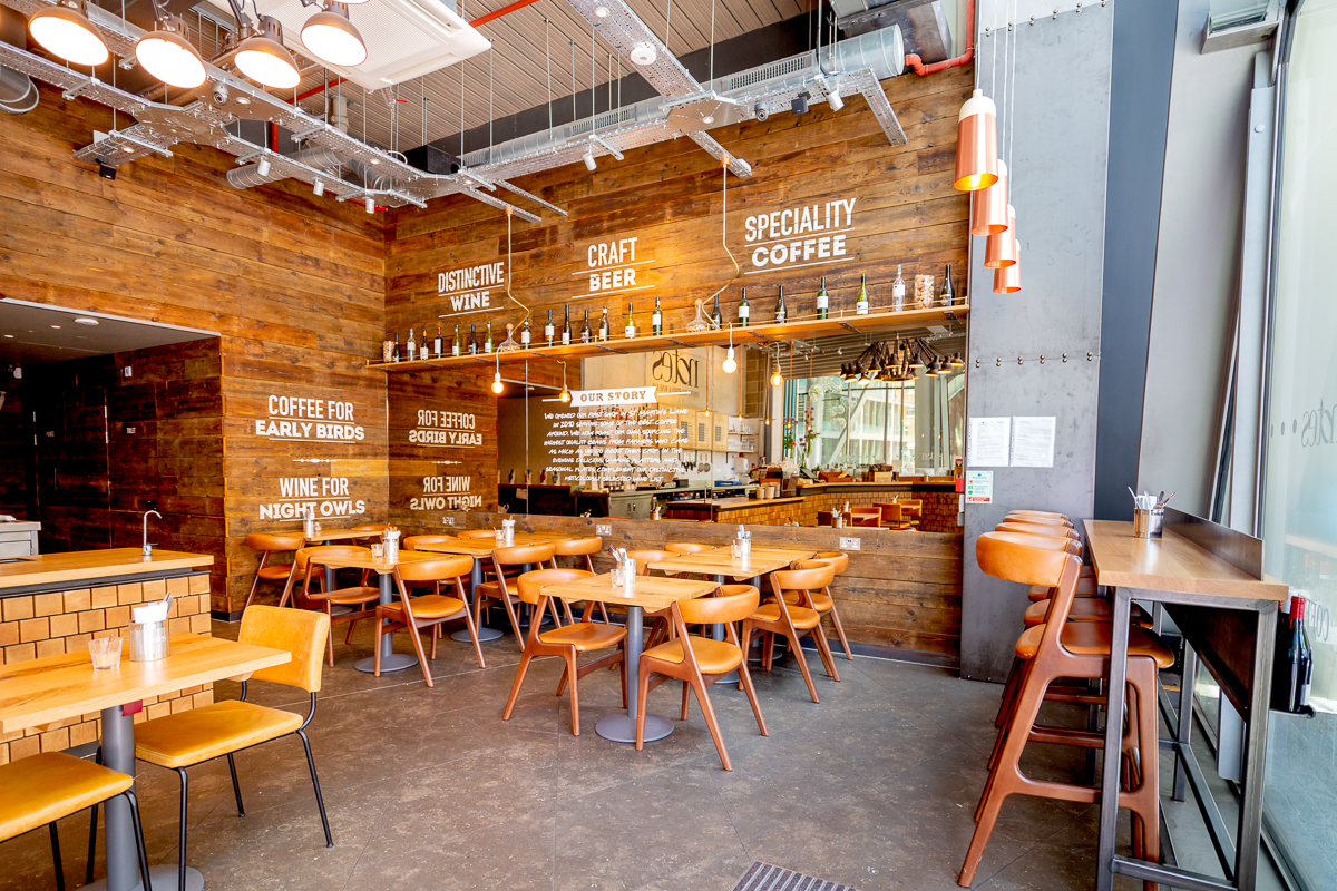 Modern café venue with wooden accents, ideal for networking events and casual meetings.