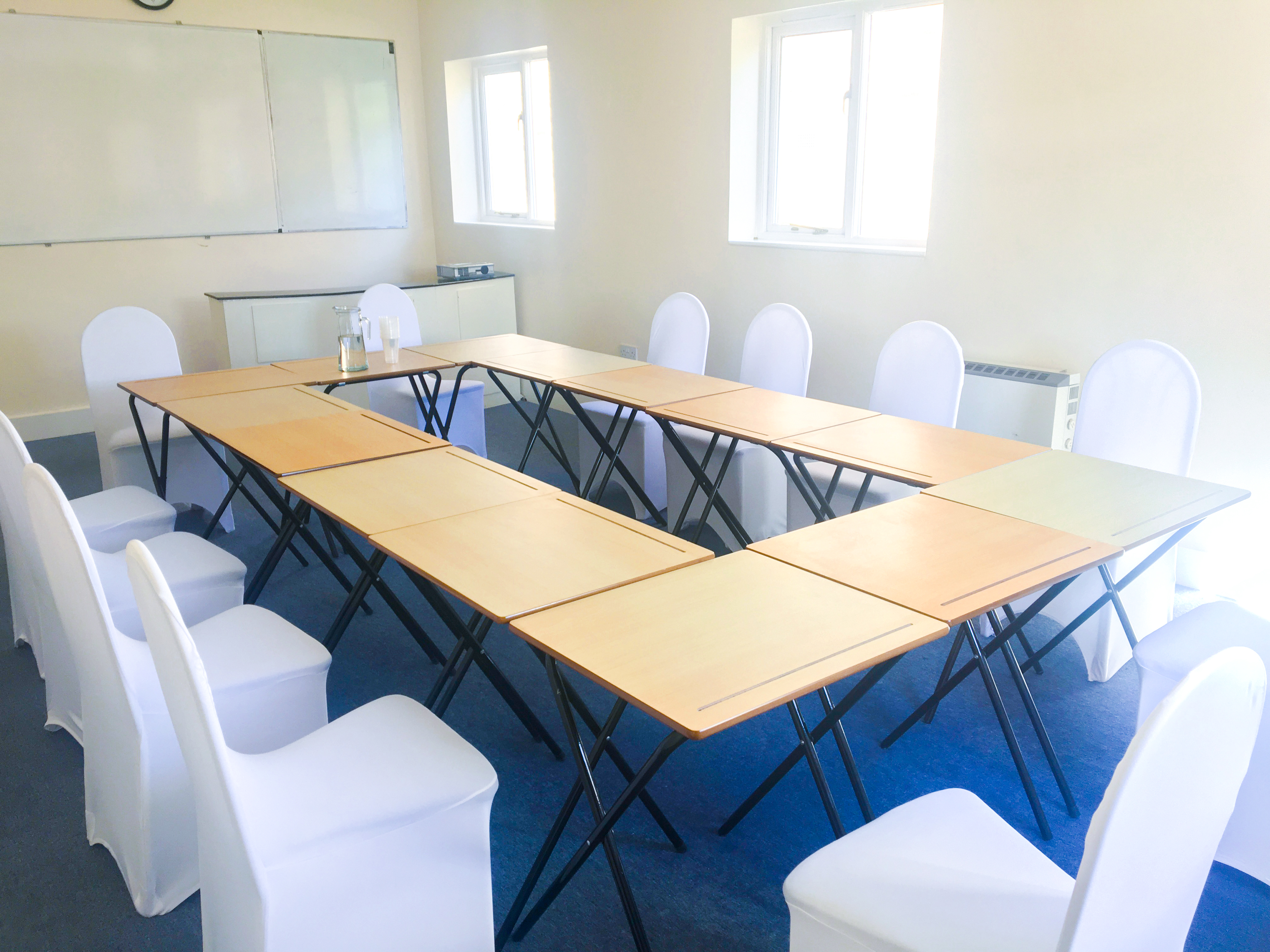 Meeting Room 101 with U-shaped table setup, ideal for workshops and strategic planning.