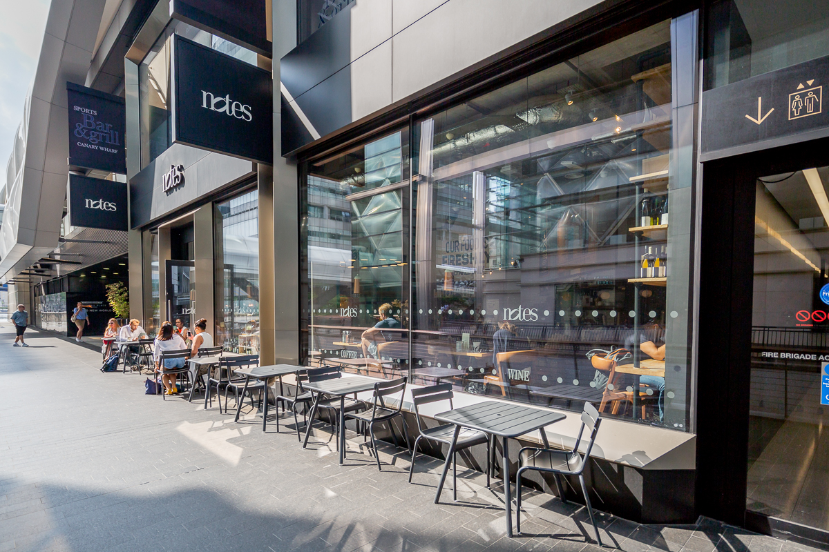 Modern café with outdoor seating at Everyman Canary Wharf, perfect for networking events.