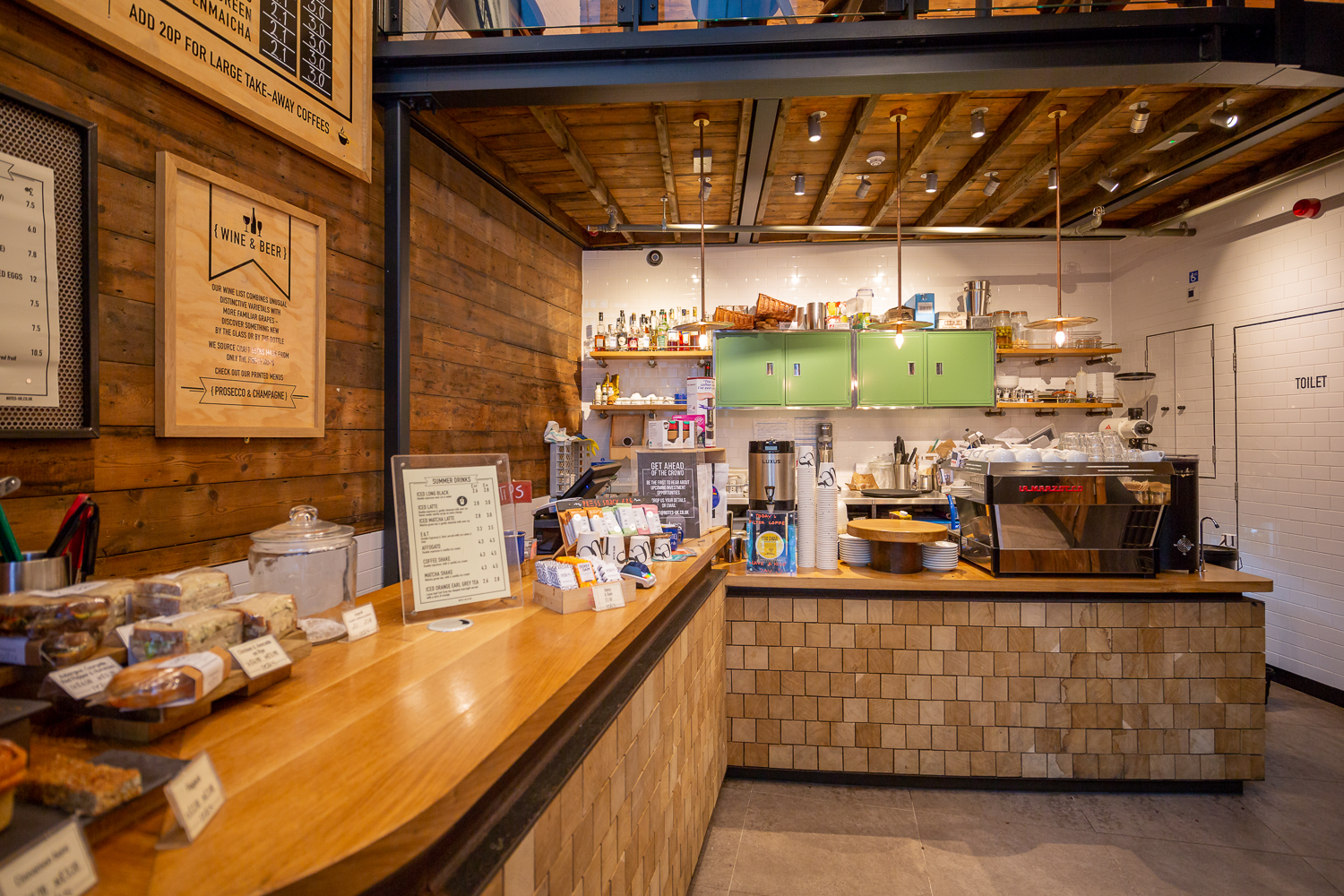 Cozy café venue with warm wood accents for networking events and informal meetings.