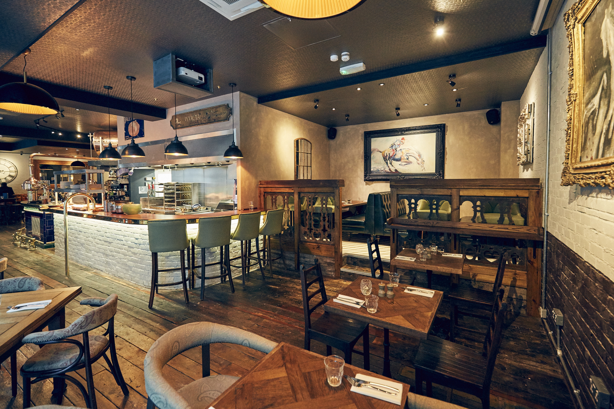 Stylish restaurant dining room with warm lighting, ideal for intimate events and gatherings.