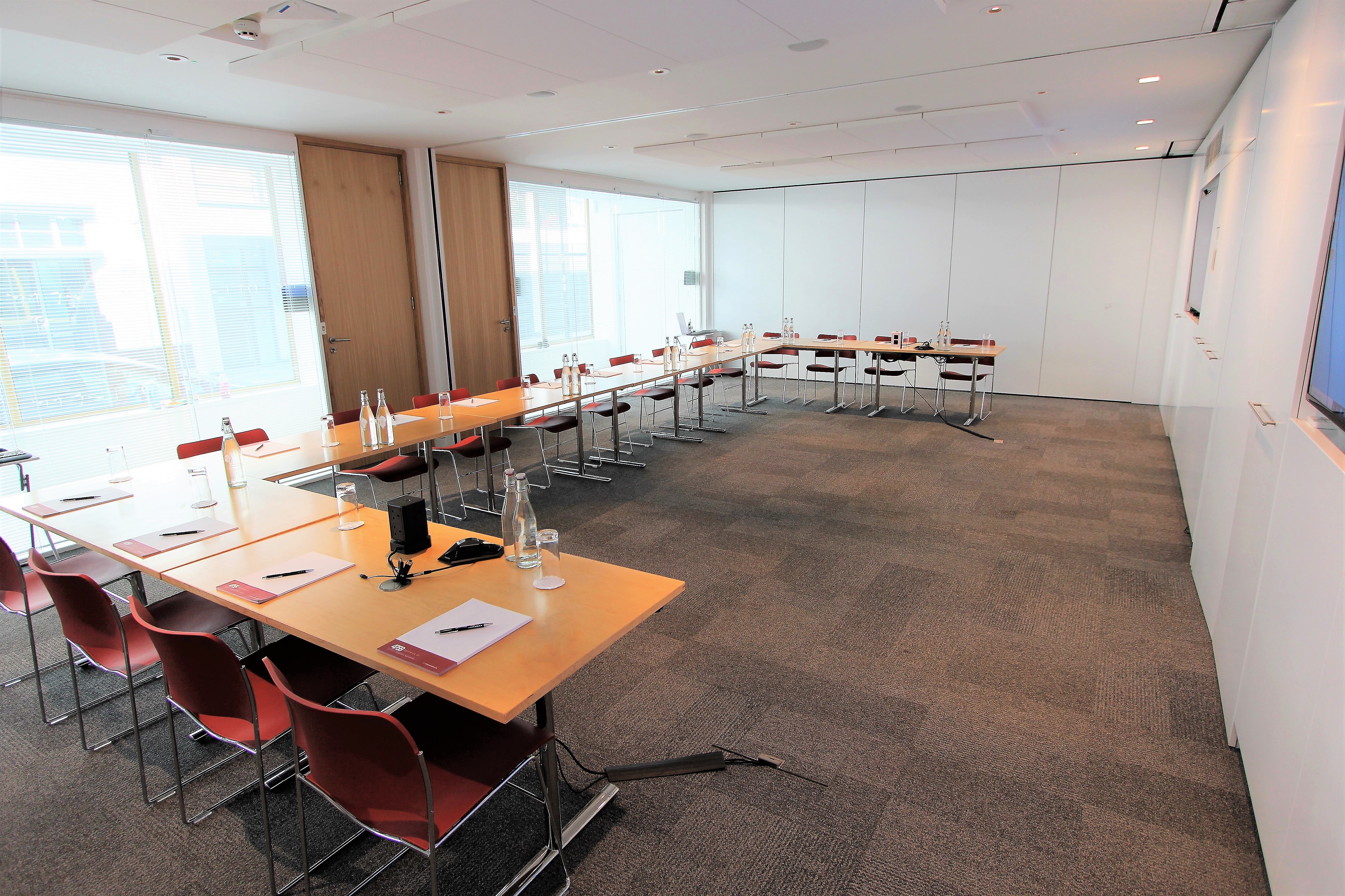 Modern Belgrave Suite meeting room with U-shaped tables for professional events.