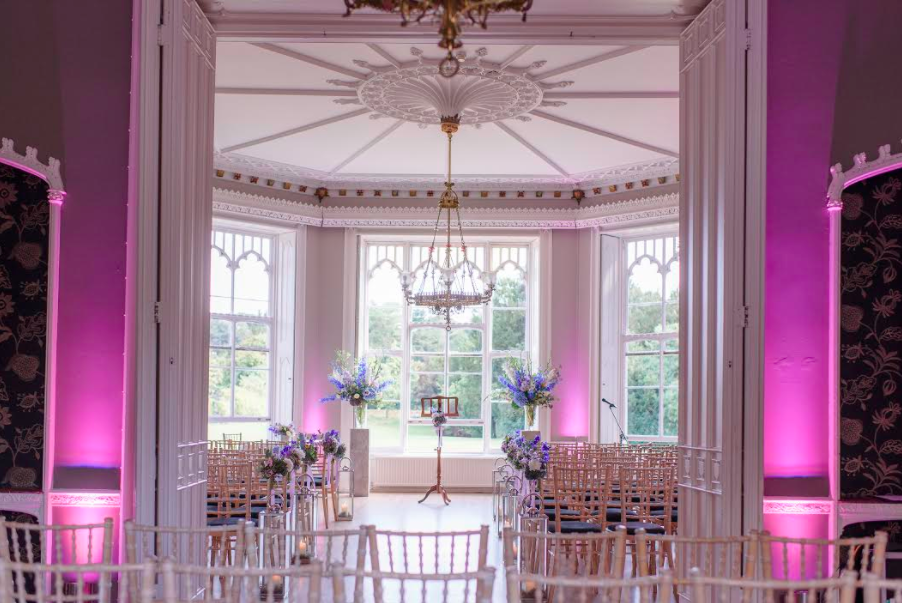 Elegant event space at Nonsuch Mansion, ideal for weddings with chiavari chairs and floral decor.