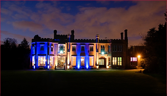 Stunning Nonsuch Mansion venue with blue lighting, ideal for weddings and corporate events.