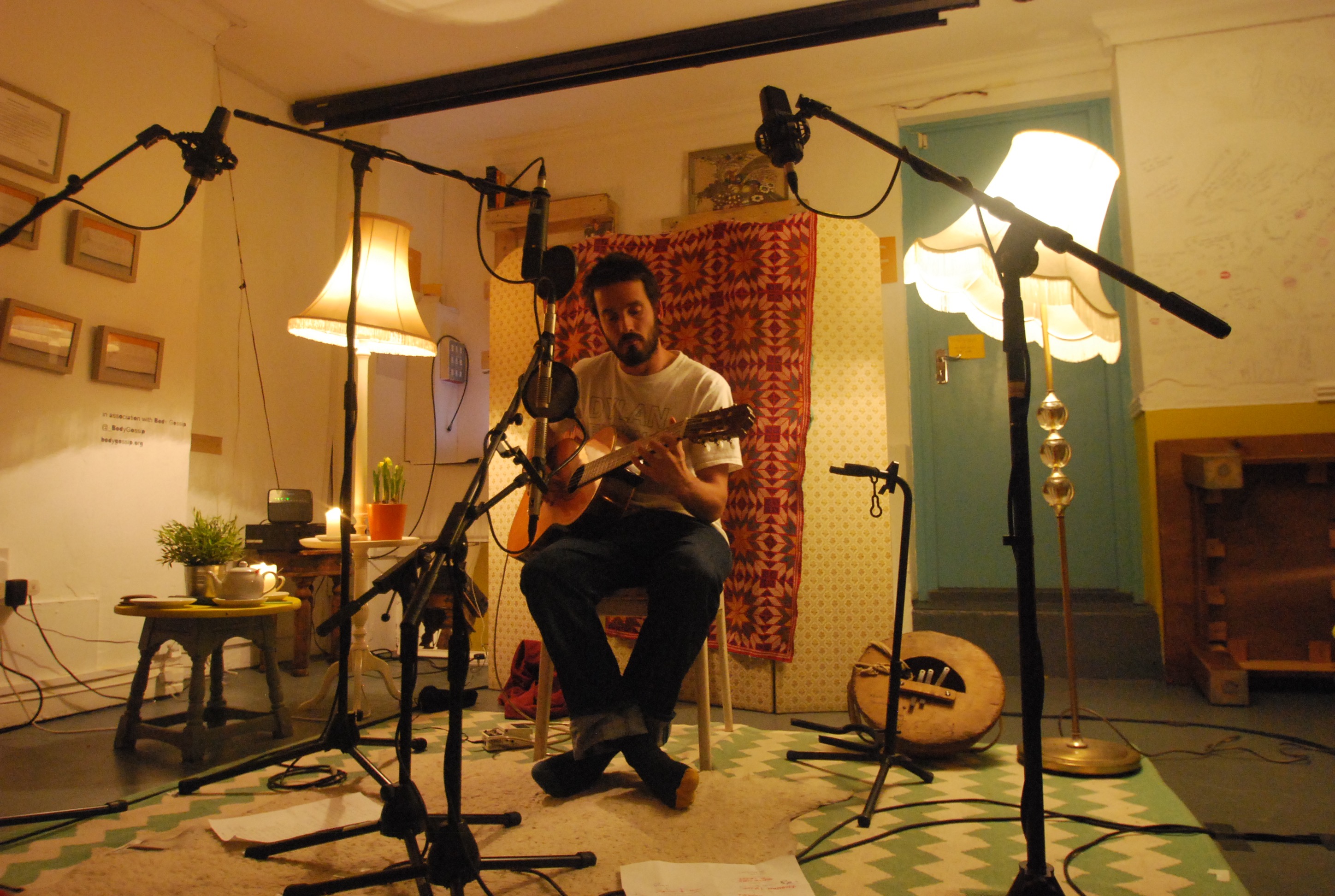 Cozy music venue with warm lighting, ideal for acoustic performances and storytelling events.