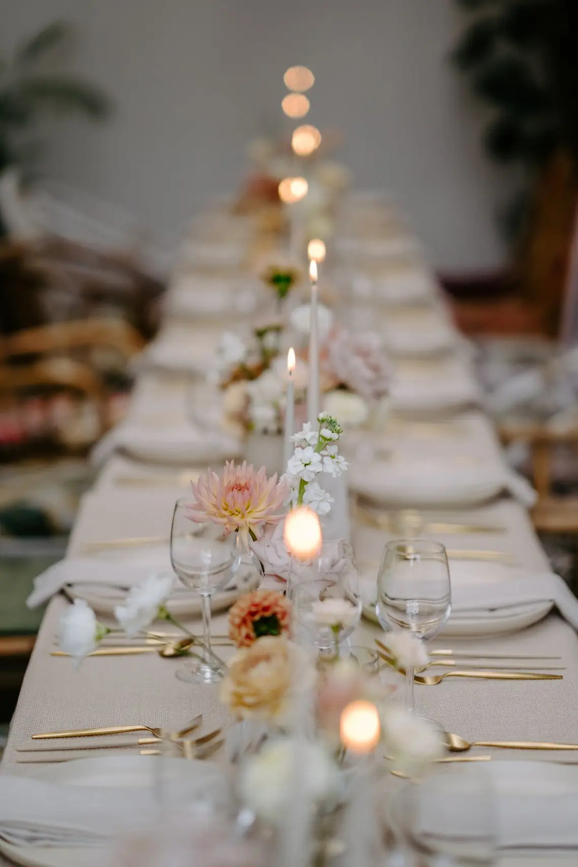 Elegant dining table with floral arrangements for upscale events in Greenhouse venue.
