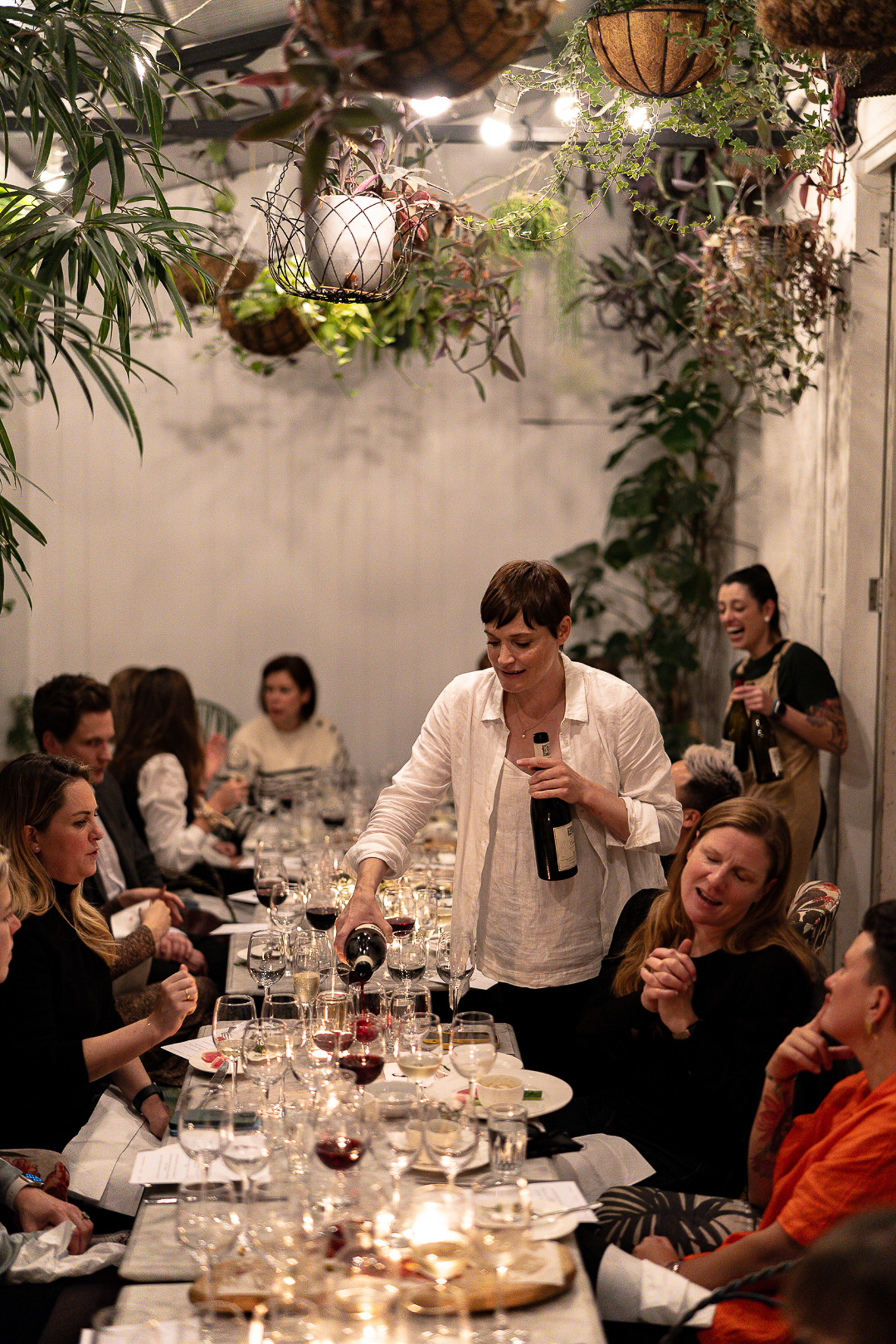 Lively dinner event in Bourne & Hollingsworth Greenhouse with attentive service and networking.