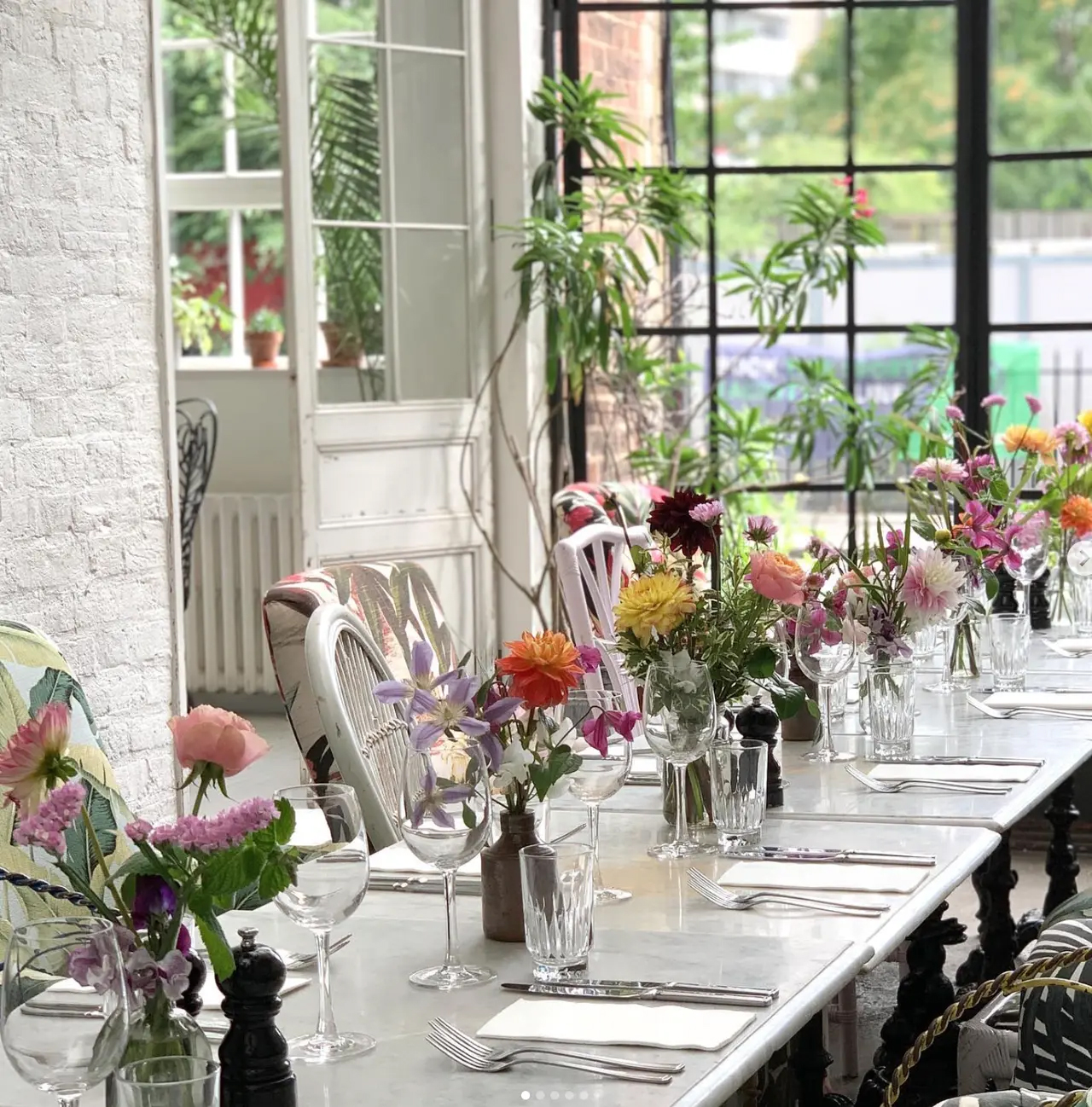 Elegant dining setup with floral centerpieces in Bourne & Hollingsworth for intimate events.