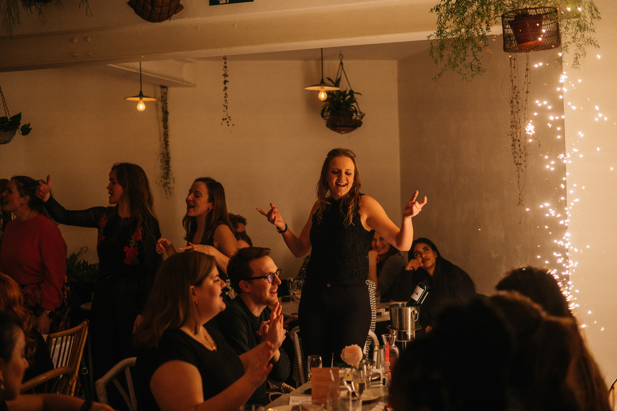 Vibrant Garden Room event with stylish decor and engaged attendees celebrating together.