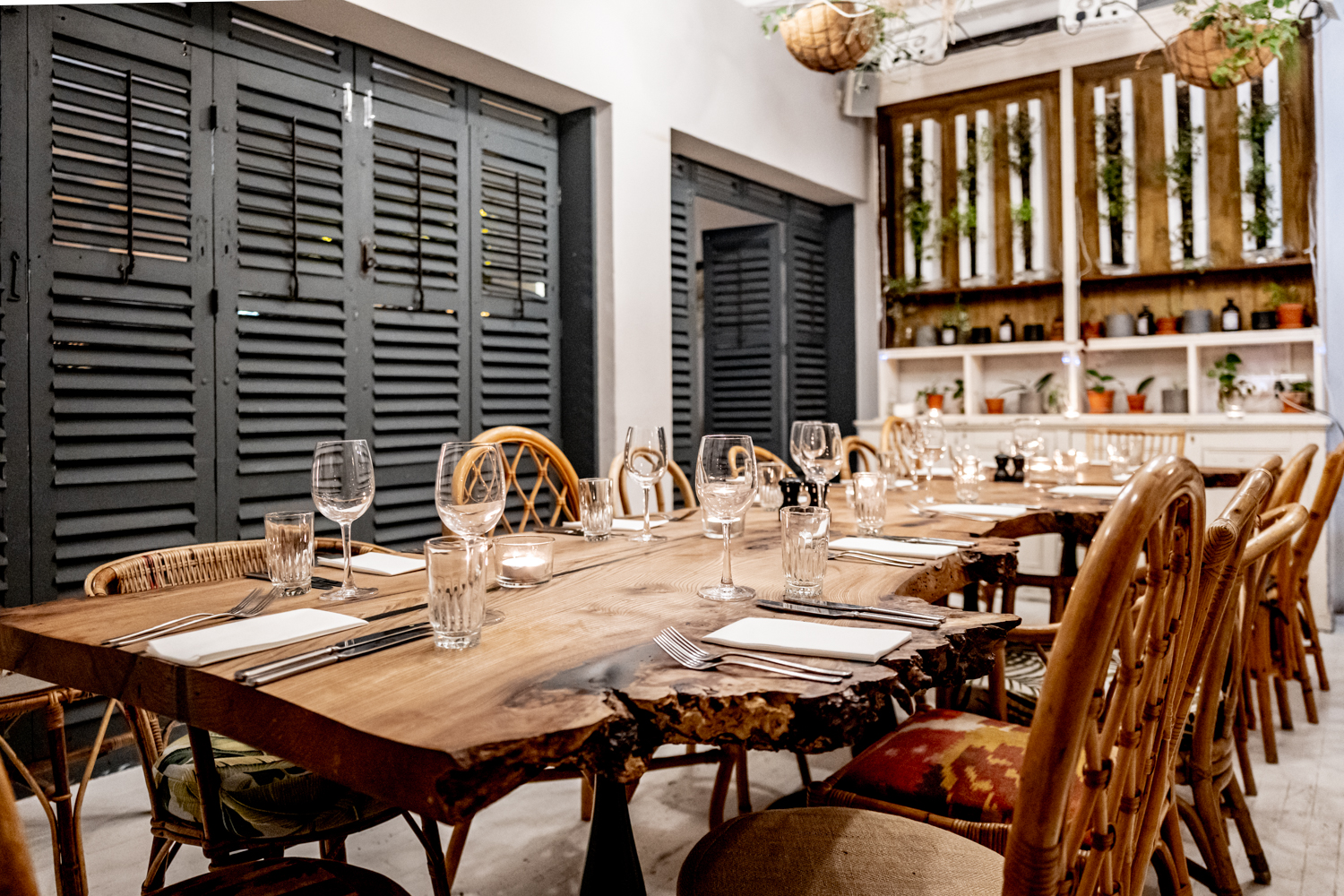 Private dining room with rustic table and rattan chairs for intimate events and meetings.