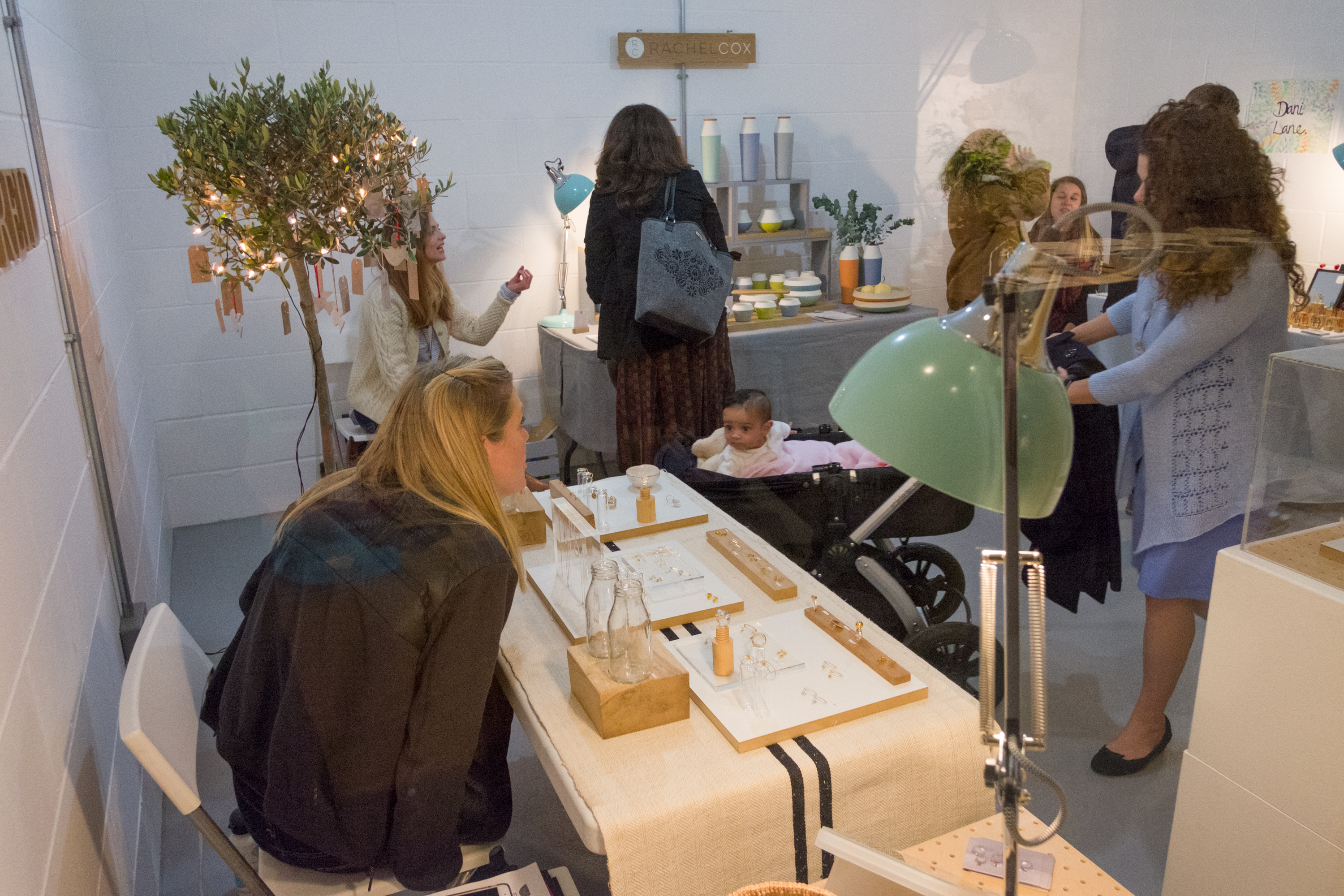 Craft Central Exhibition Hall with vendors, greenery, ideal for community craft fairs.