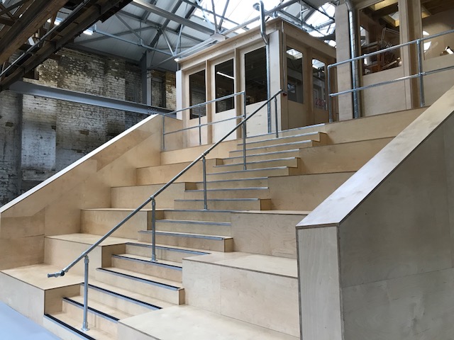 Multi-level stage in Craft Central's Exhibition Hall for presentations and performances.