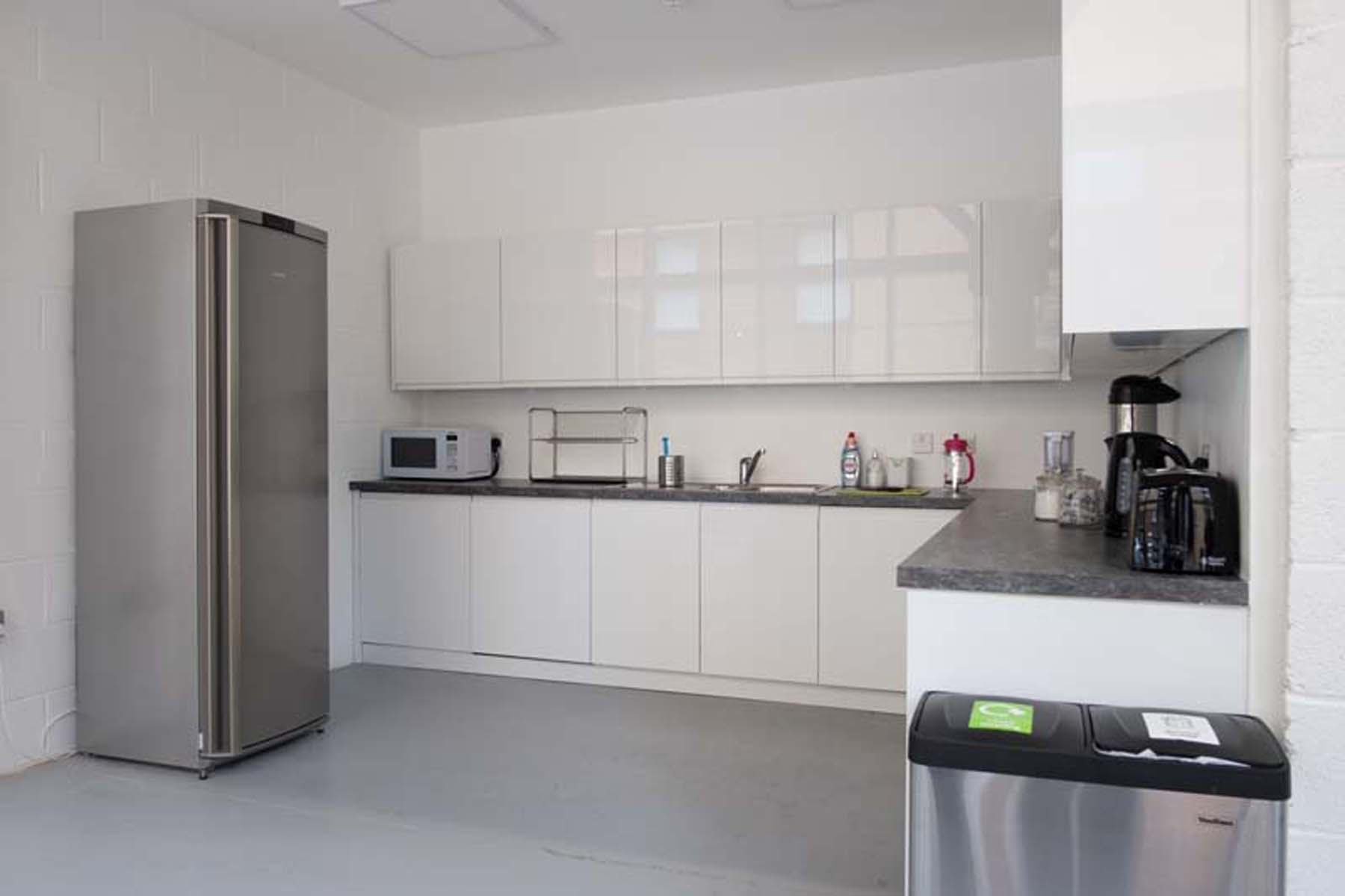 Multipurpose meeting room kitchen with sleek design for events and catering.