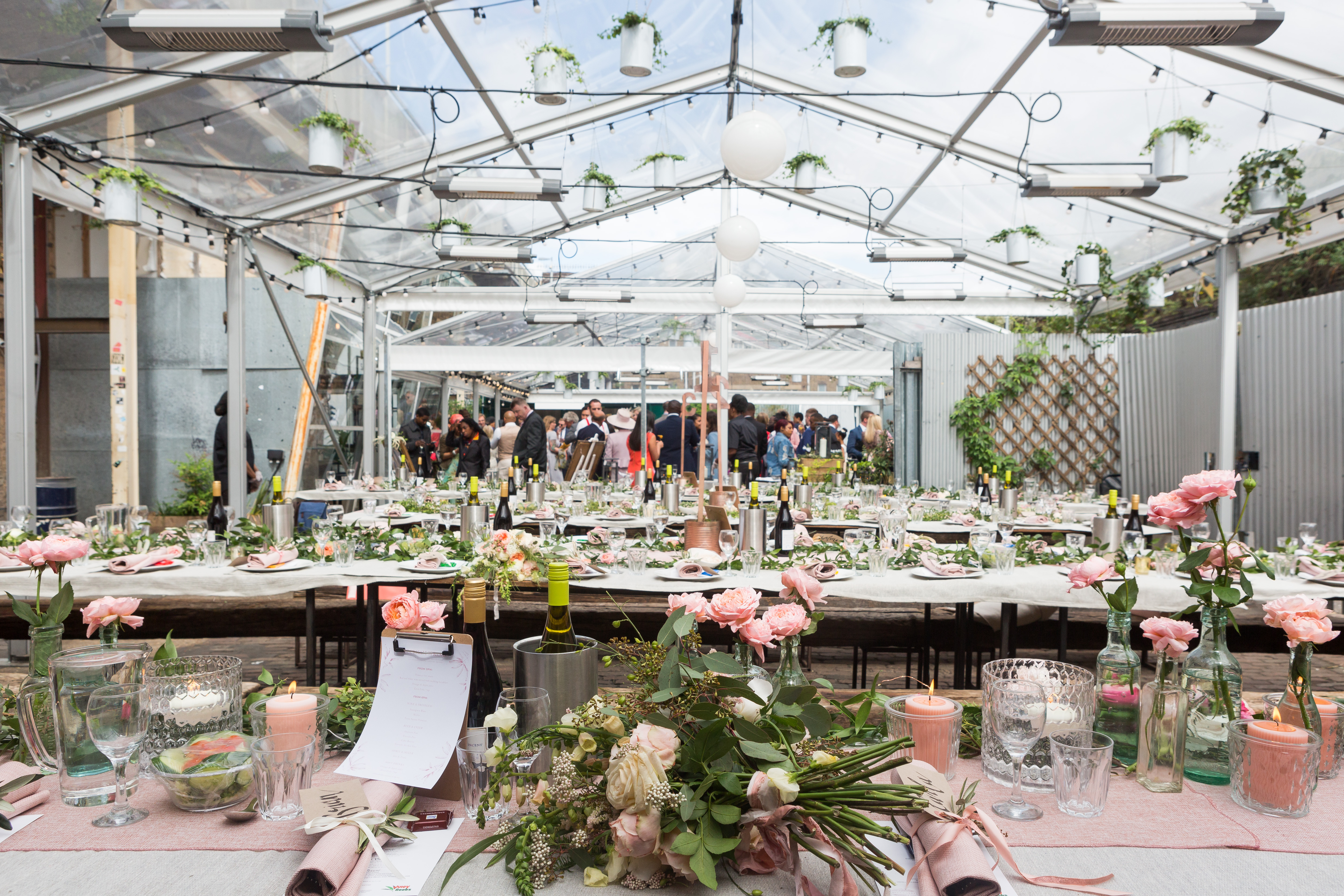 "Elegant Palm House event space with pink linens, perfect for weddings and corporate events."