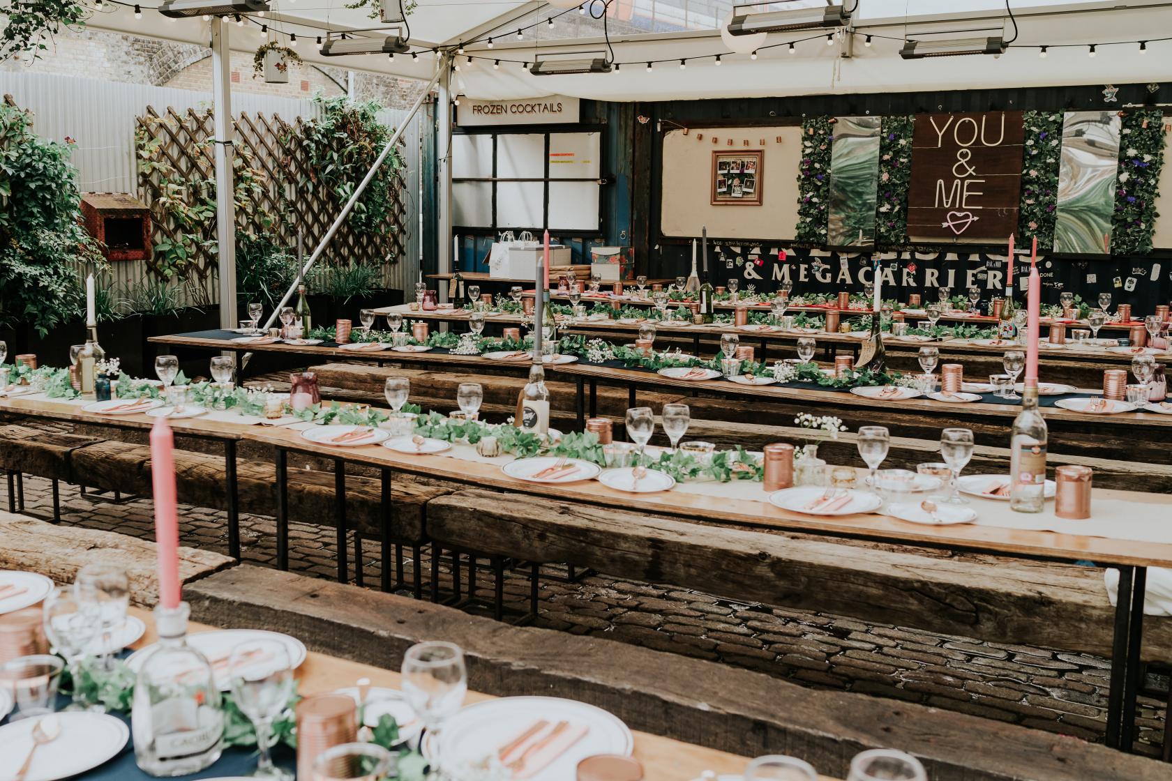 Outdoor dining setup at Palm House, Peckham Springs - rustic tables for events, ambiance.