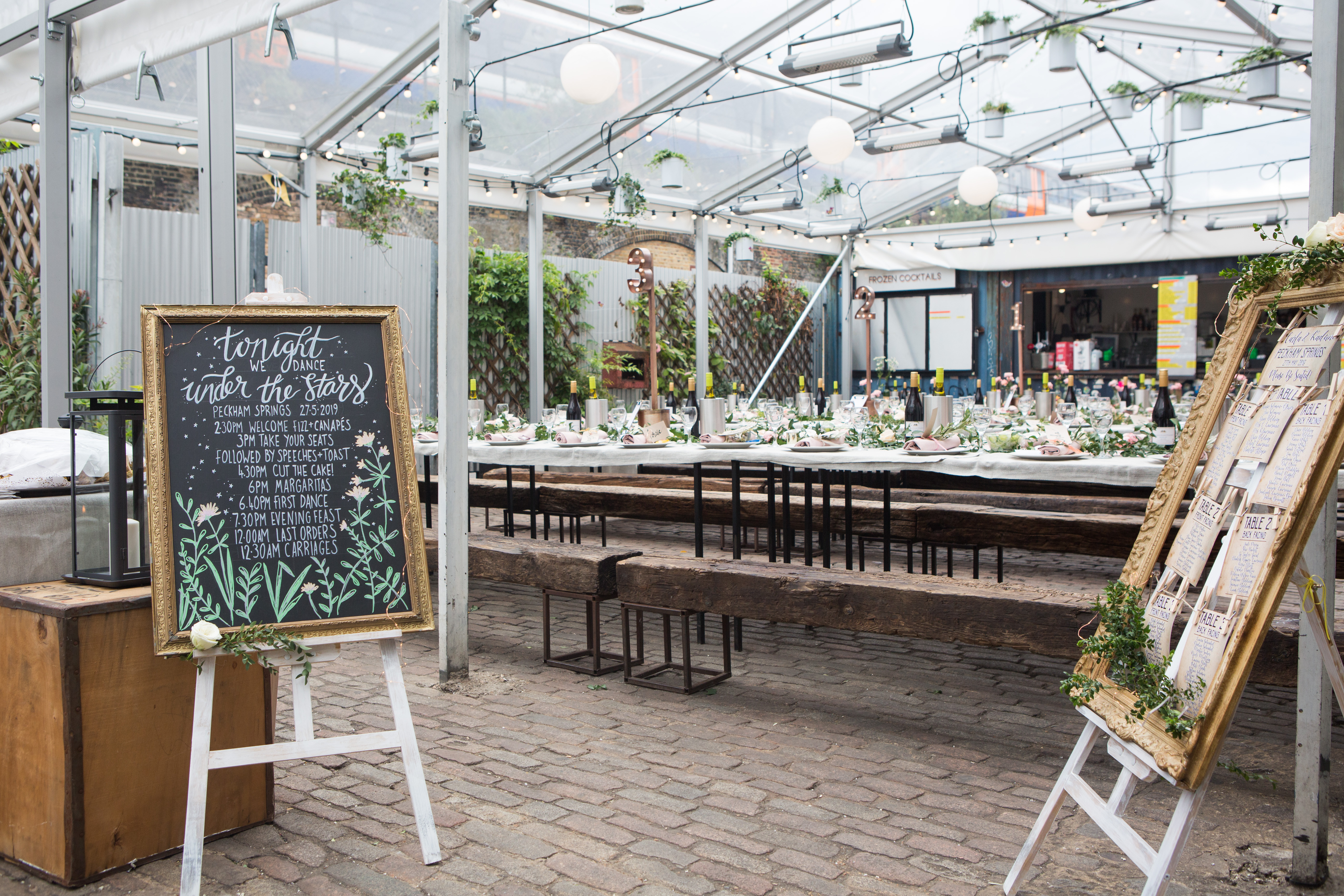 Palm House Peckham Springs: elegant glass greenhouse for events with communal tables.