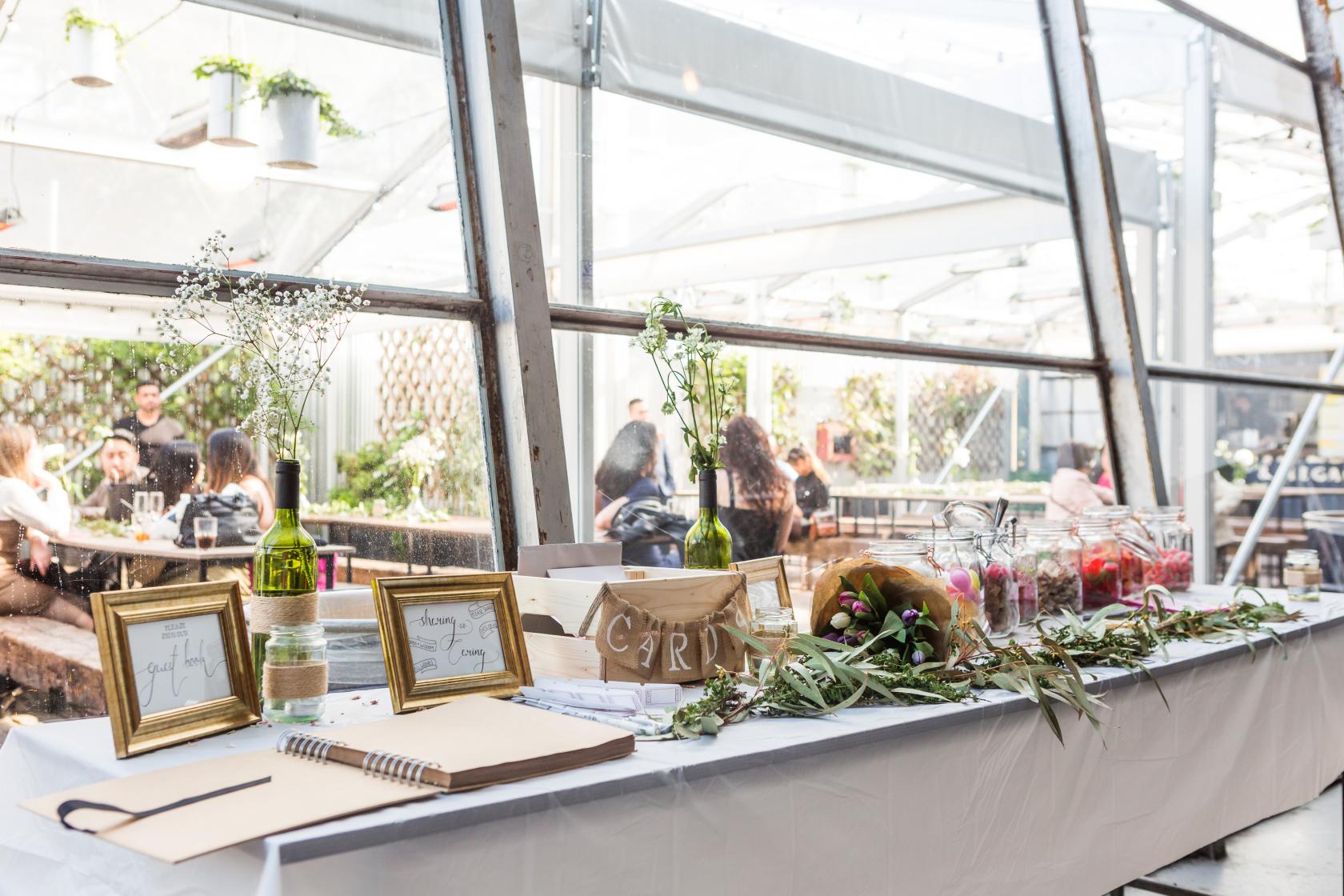 Stylish event setup at Springs Bar & Garden with candles and foliage, perfect for gatherings.