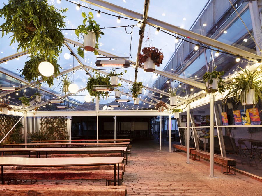 Versatile Peckham Springs venue with string lights, perfect for workshops and gatherings.