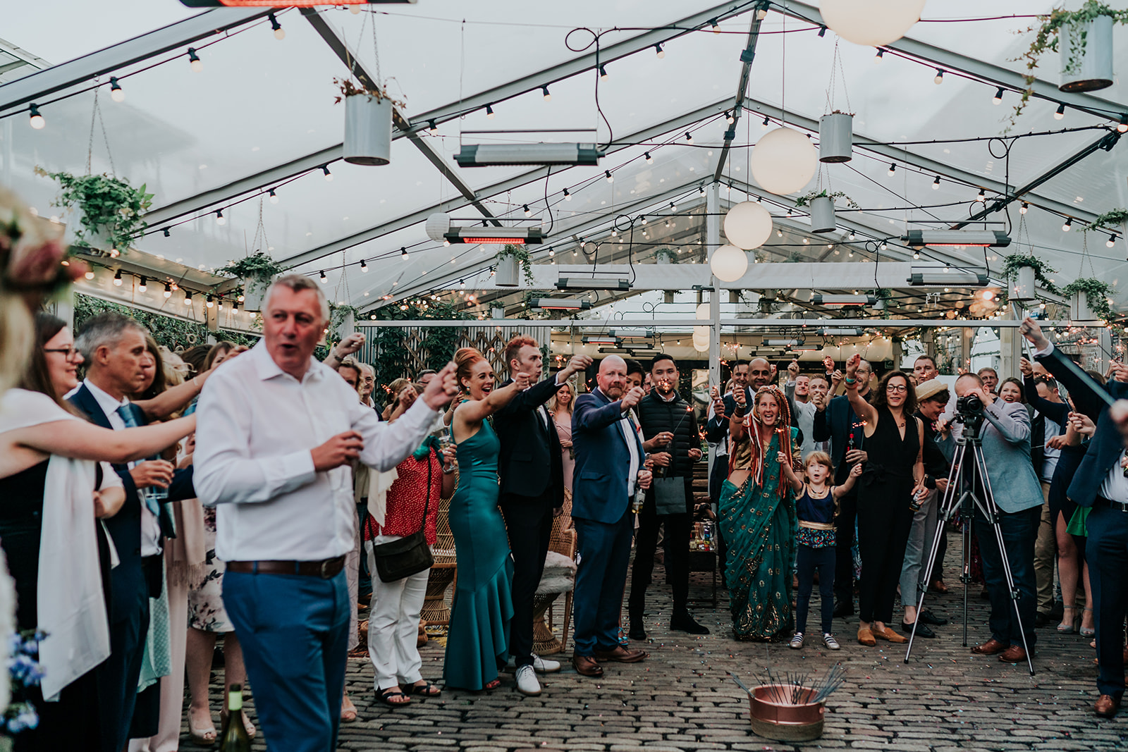 Vibrant greenhouse event at Peckham Springs with string lights, perfect for weddings.