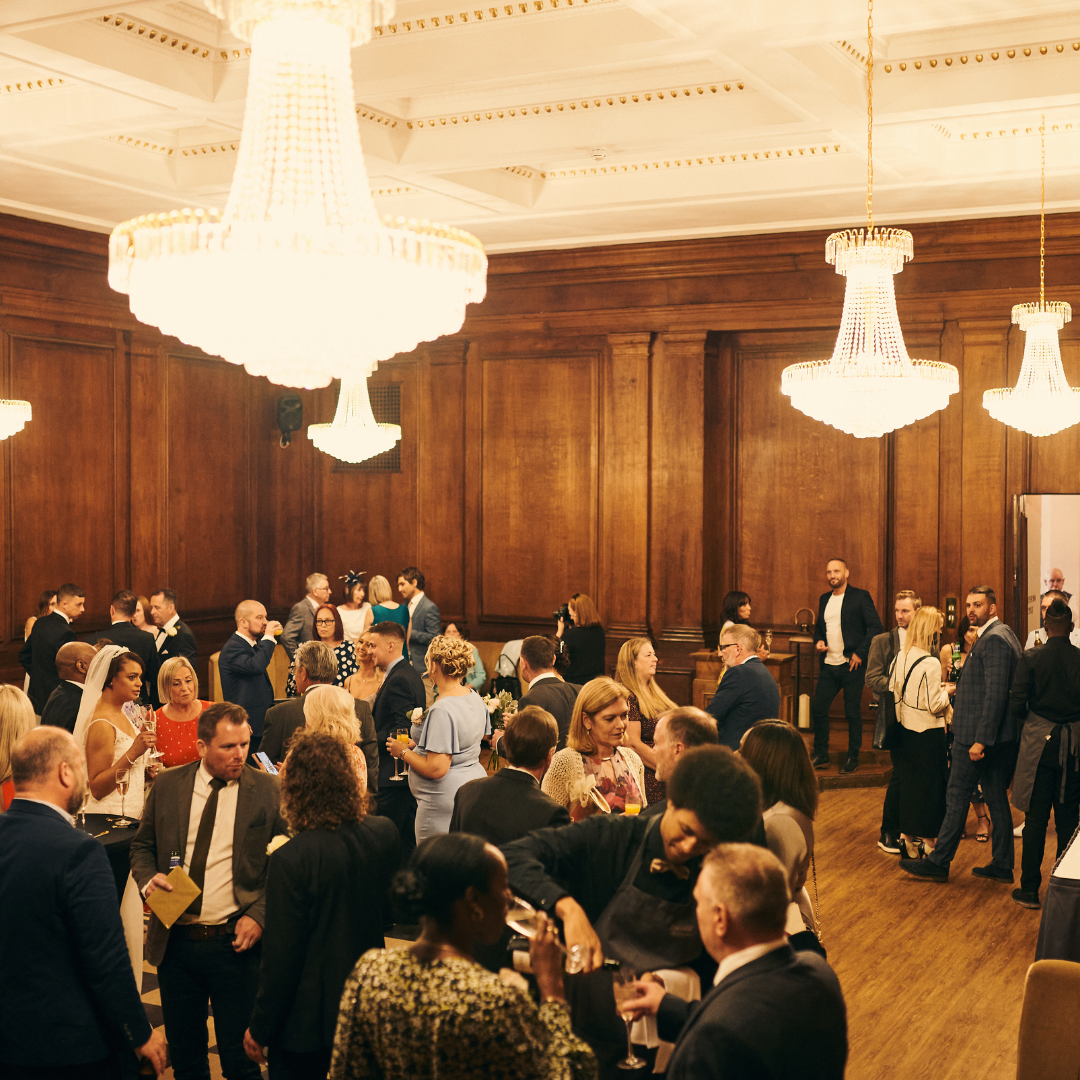 Vibrant networking event at Goulburn Lodge, featuring elegant chandeliers and warm wood paneling.