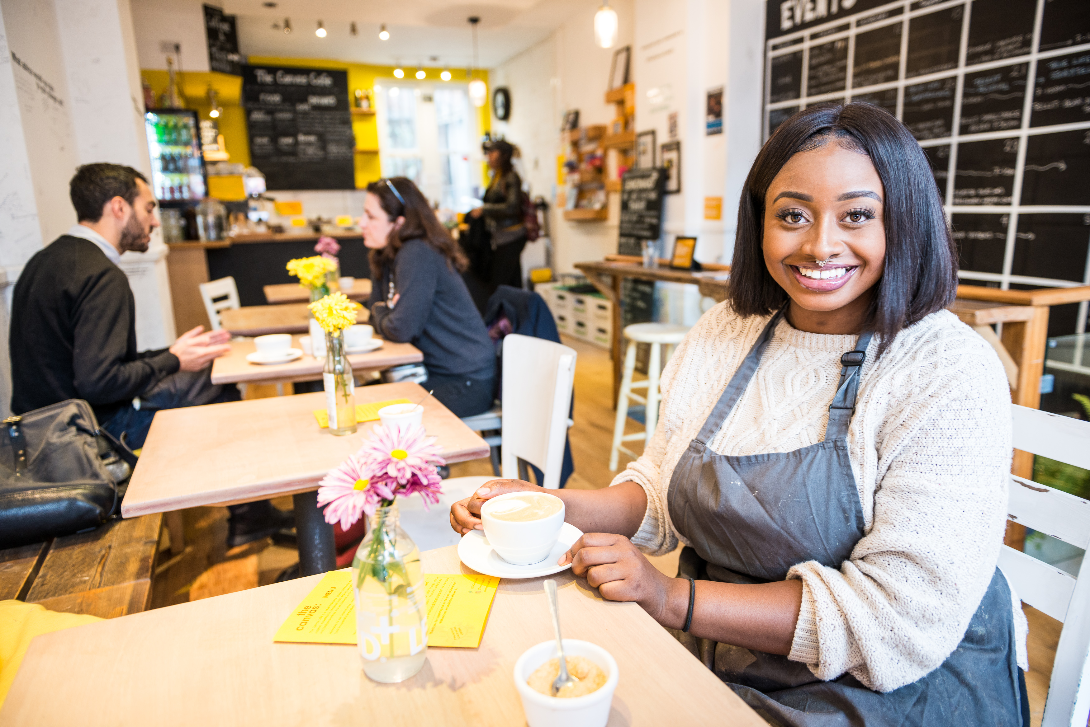 Charming cafe setting with fresh flowers, ideal for networking events and casual meetups.