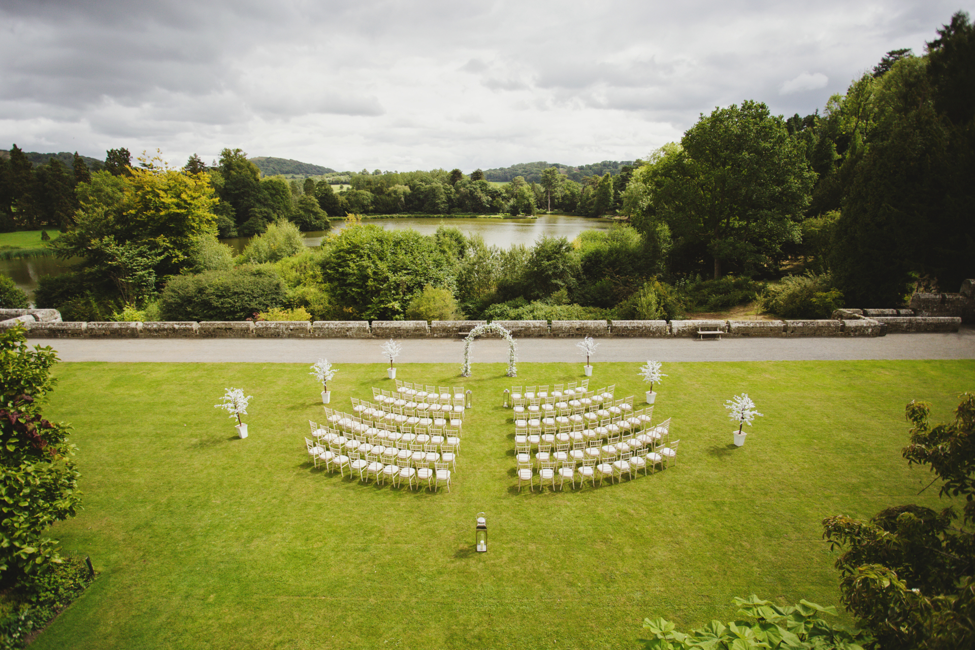 Outdoor wedding venue at Eastnor Castle with elegant archway and lush greenery.