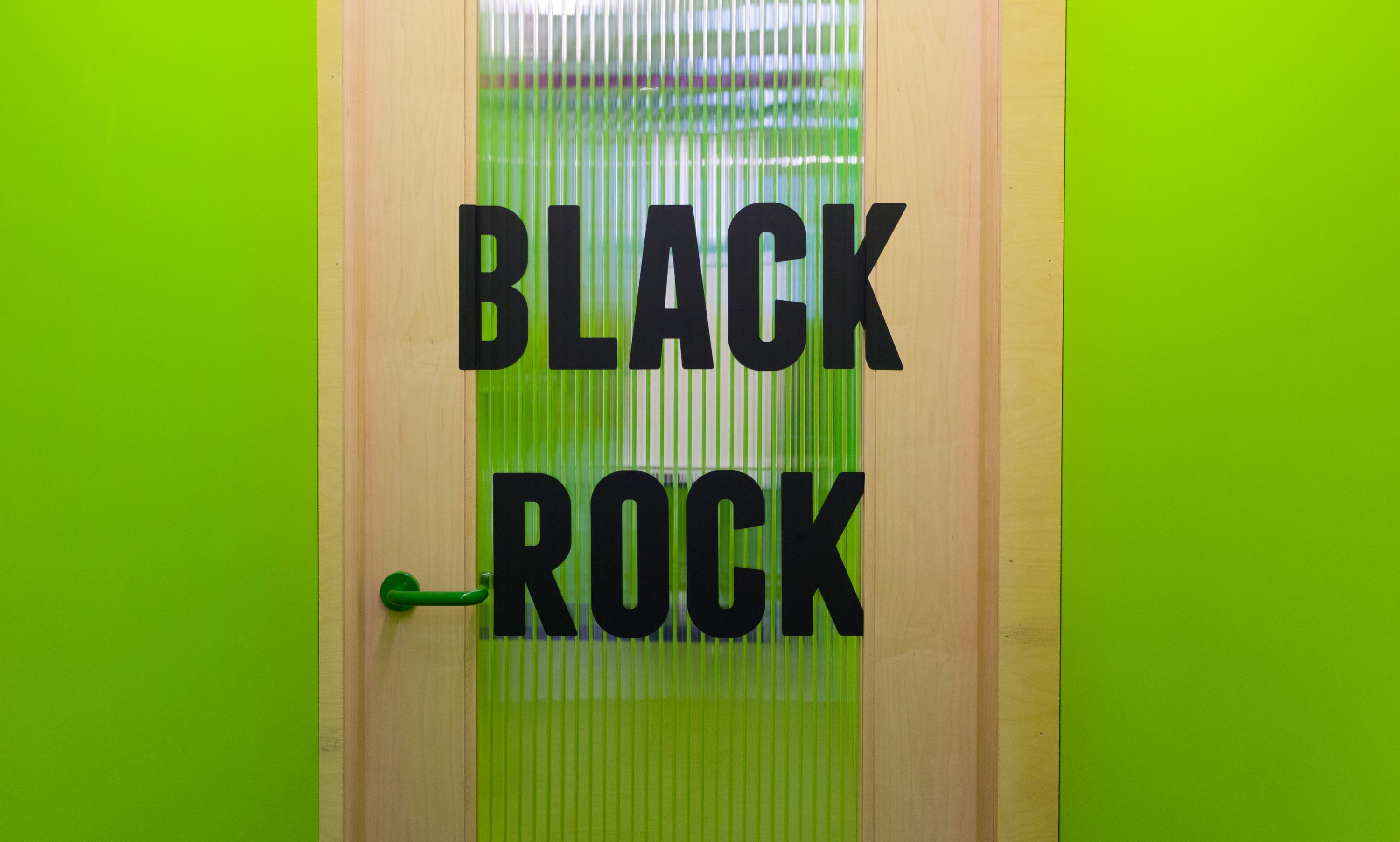 Black Rock Meeting Room with vibrant green door, ideal for creative workshops and meetings.