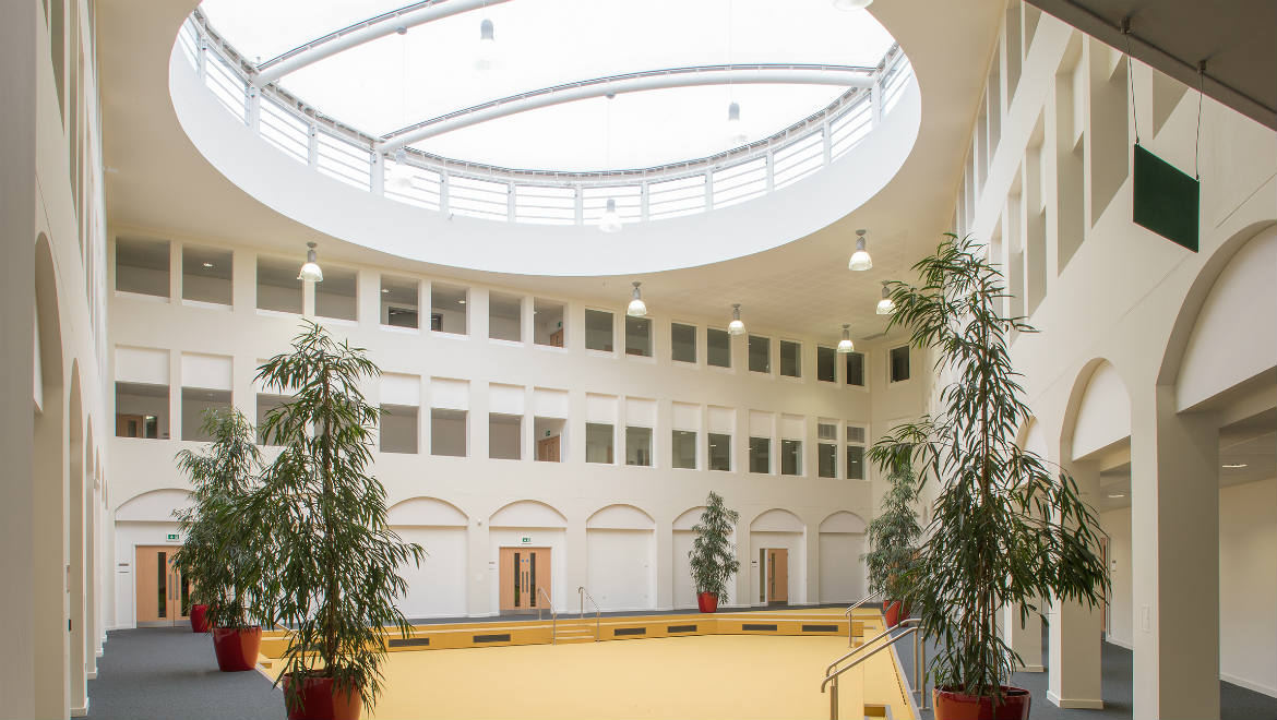 Spacious Conference Hall at Nishkam Centre with high ceiling, ideal for events and receptions.