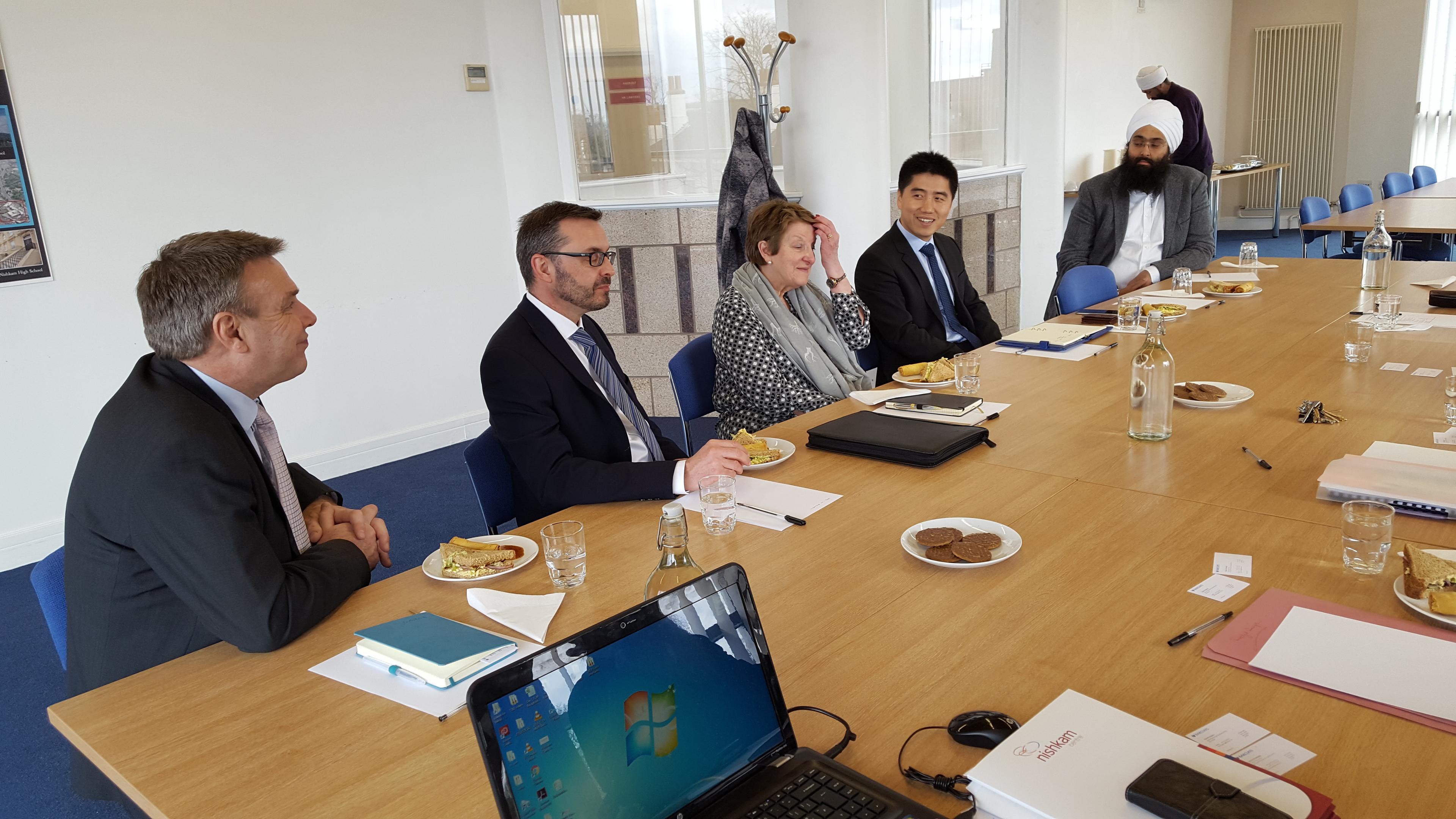 Conference Hall in Nishkam Centre with attendees discussing during a professional meeting.