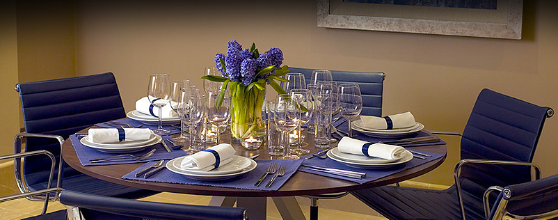 Private Suite 10 dining table with floral centerpiece for upscale corporate events.
