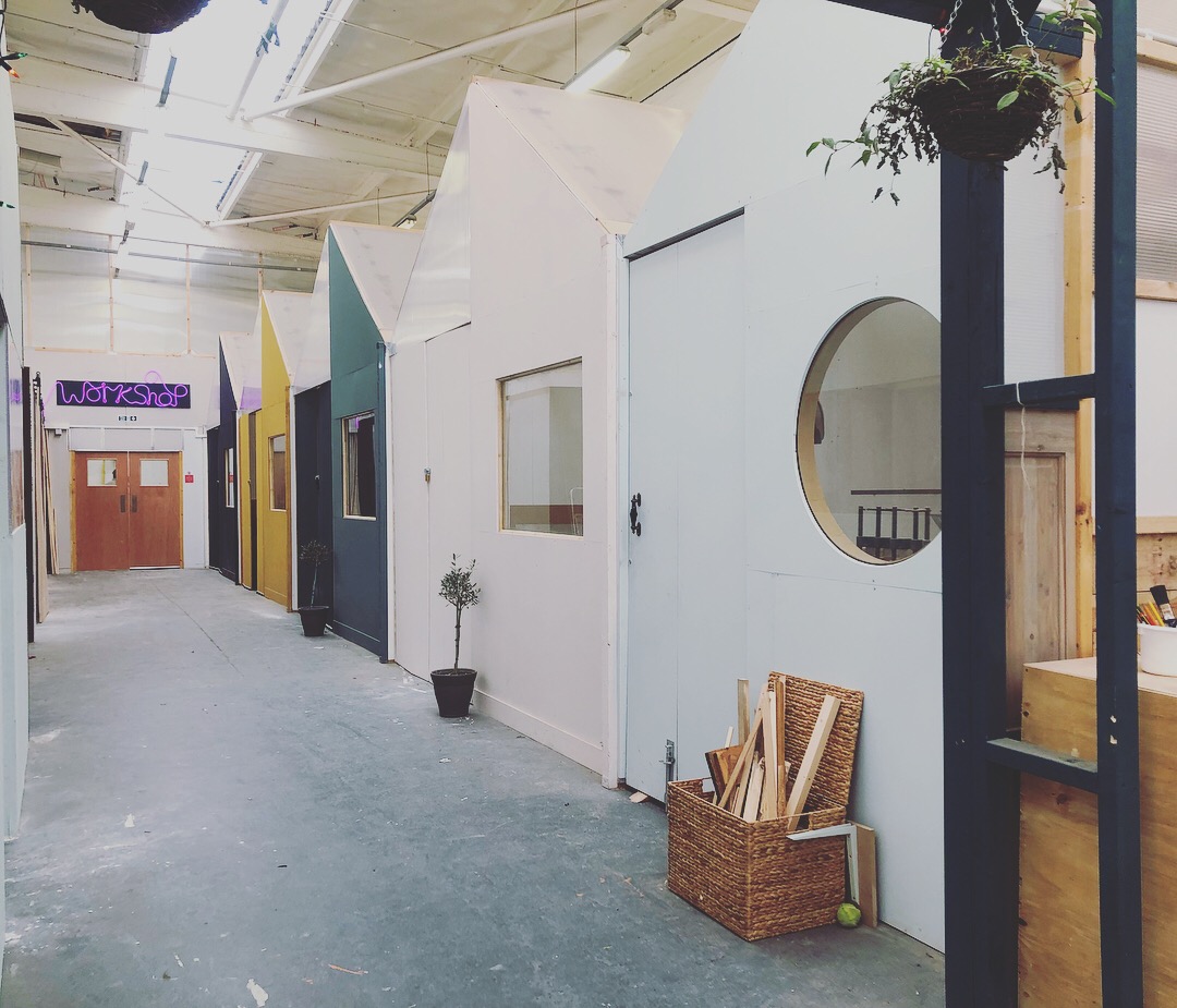 Colorful house-like structures in The Craftyard, ideal for creative workshops and events.