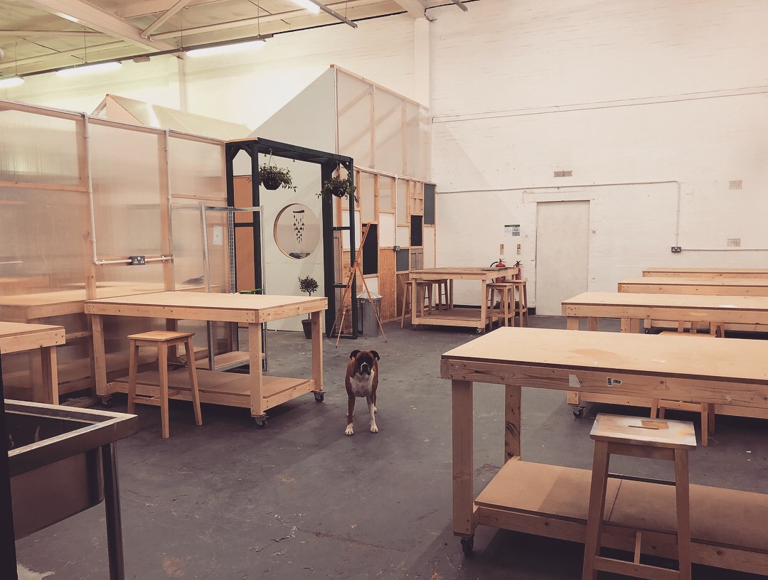 Versatile event space in Makers Quarter with wooden tables, ideal for workshops and gatherings.