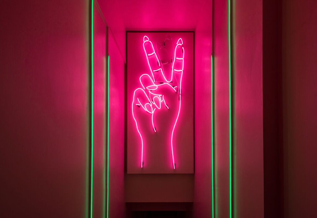 Vibrant neon peace sign in trendy event space at Tonight Josephine Waterloo.