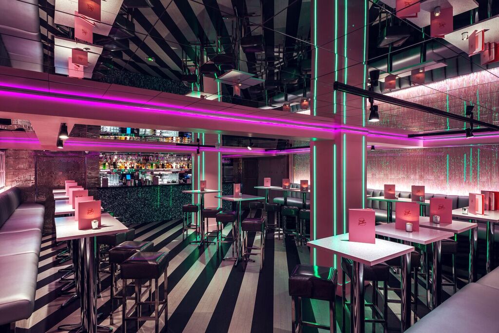 Modern event venue with bold lighting, ideal for networking and cocktail receptions.