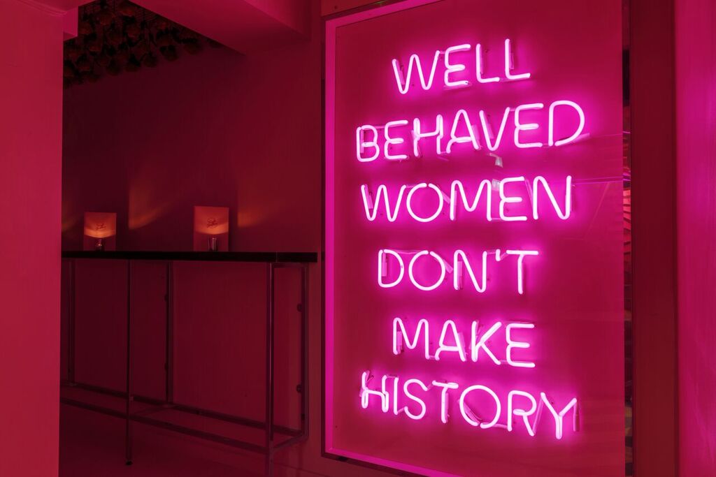 Vibrant neon sign at Tonight Josephine Waterloo for women's empowerment events.