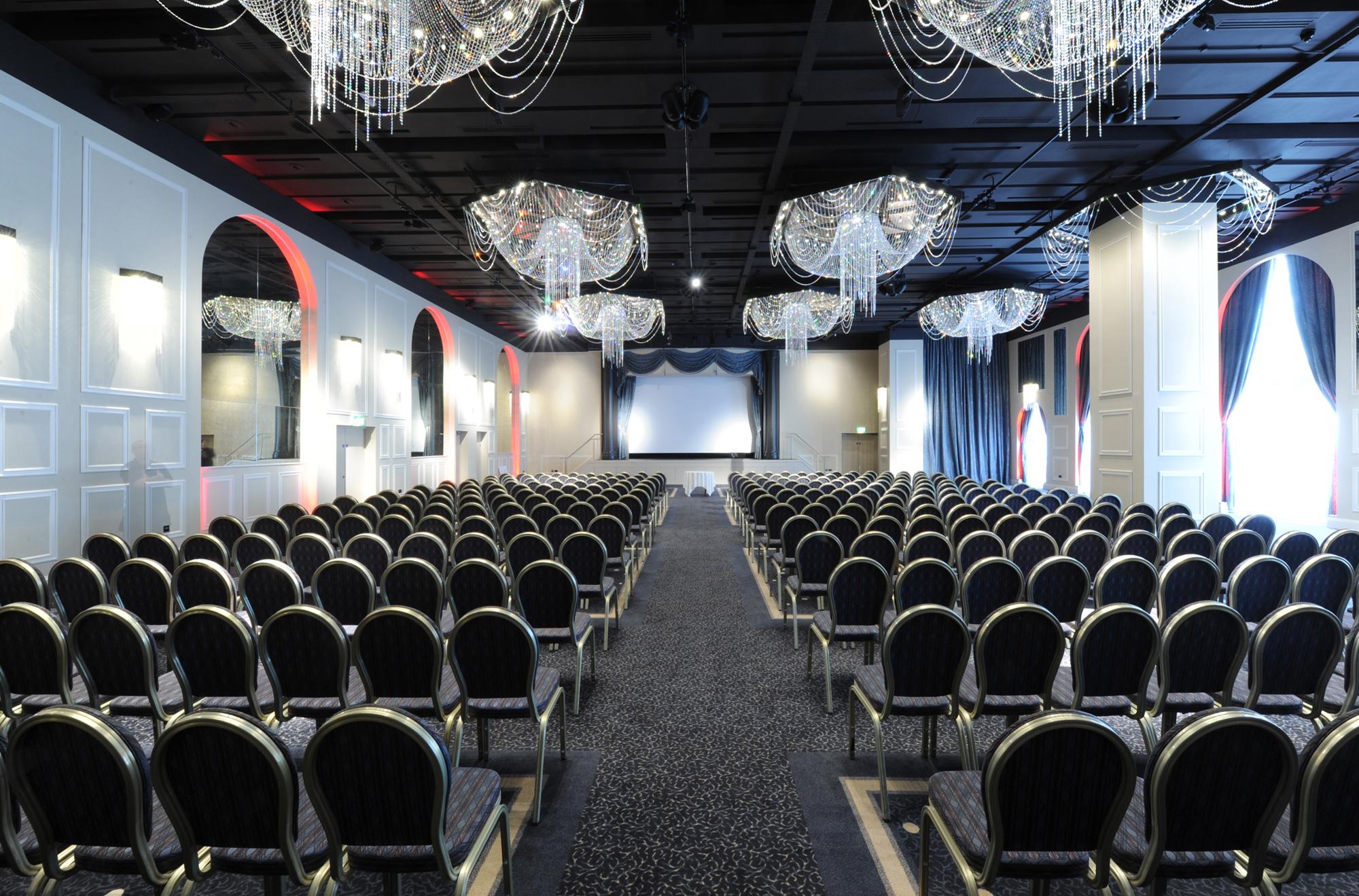 International Suite at Mercure Manchester, elegant conference venue with chairs and screen.