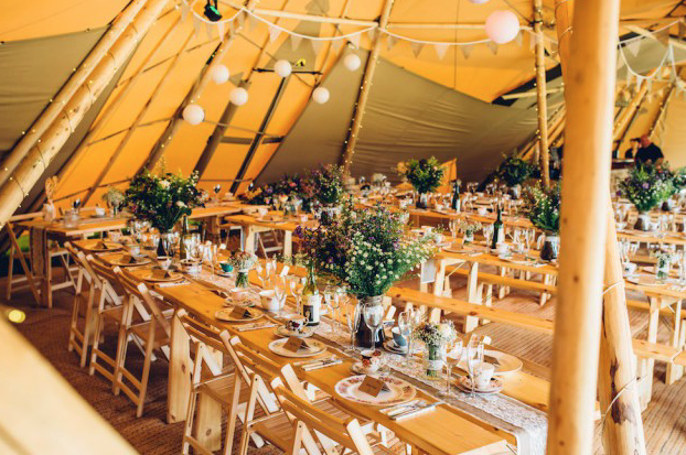 Elegant wedding setup with floral centerpieces at Roundoak Farm event space.