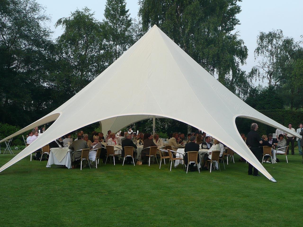 Elegant outdoor wedding setup under a white tent at Roundoak Farm.