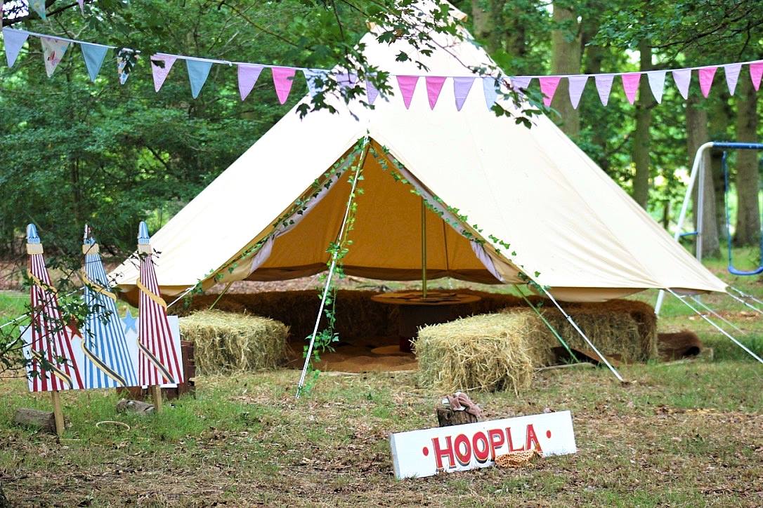 Charming outdoor wedding venue with tent, bunting, and rustic seating at Roundoak Farm.