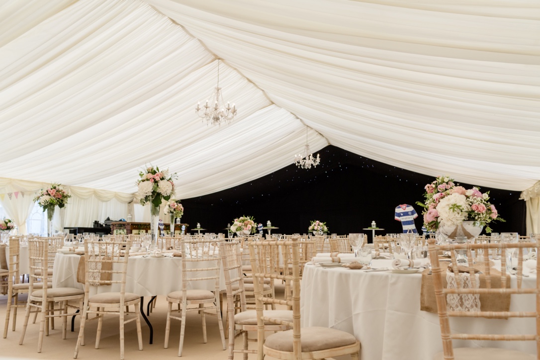 Elegant marquee with floral centerpieces for upscale weddings and events at Roundoak Farm.
