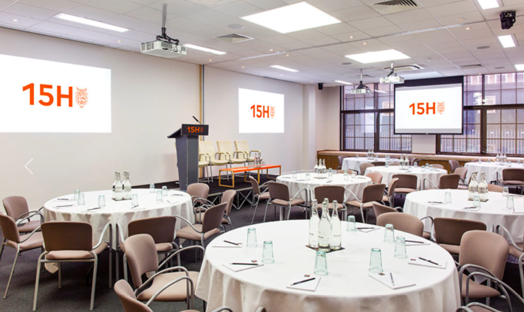 Professional meeting space with round tables, ideal for events and networking.