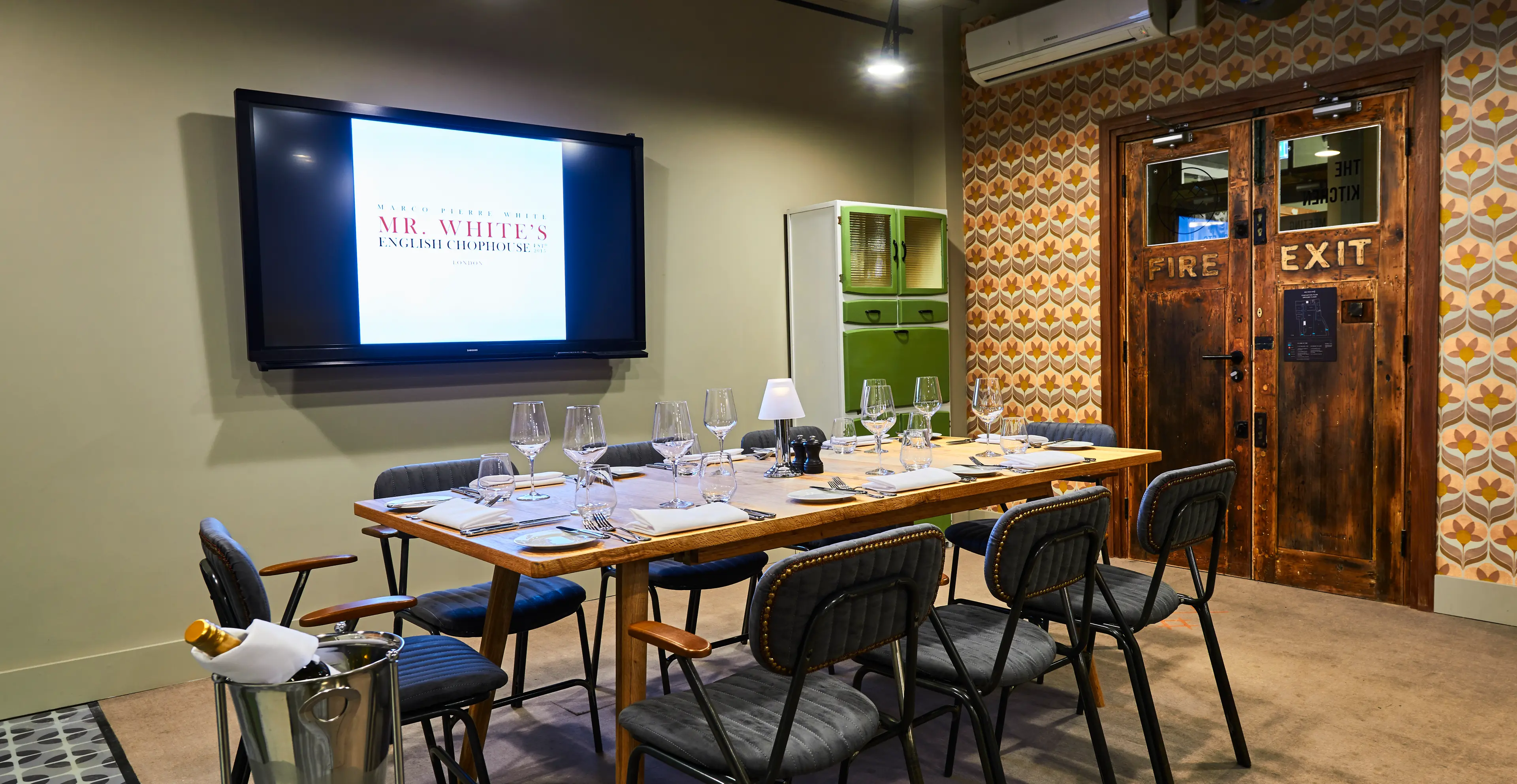 Elegant meeting room with wooden table for corporate dinners and events.