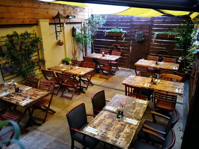 Charming outdoor dining space at Rullo's, perfect for intimate gatherings and events.