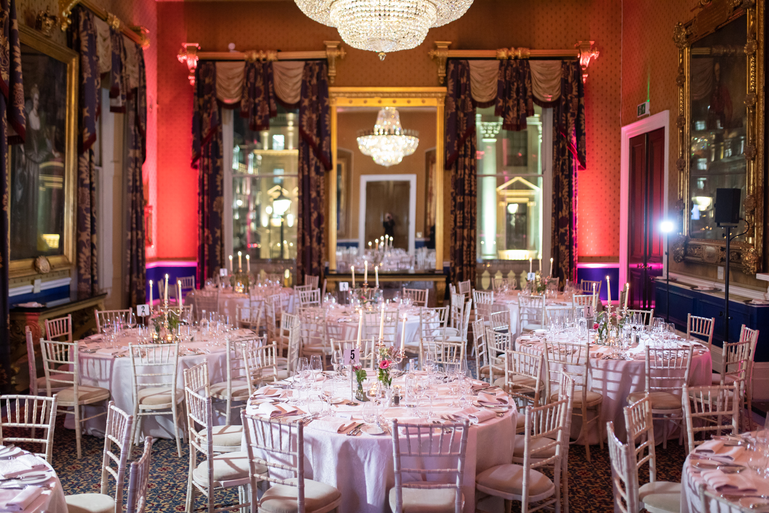 Elegant banquet hall at Waterloo, featuring round tables and floral centerpieces for weddings.