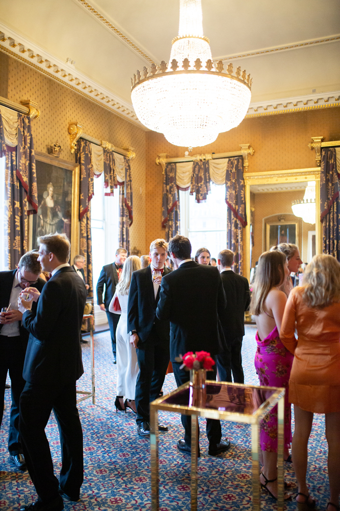 Elegant networking event at Waterloo, 116 Pall Mall, with formal attire and opulent decor.