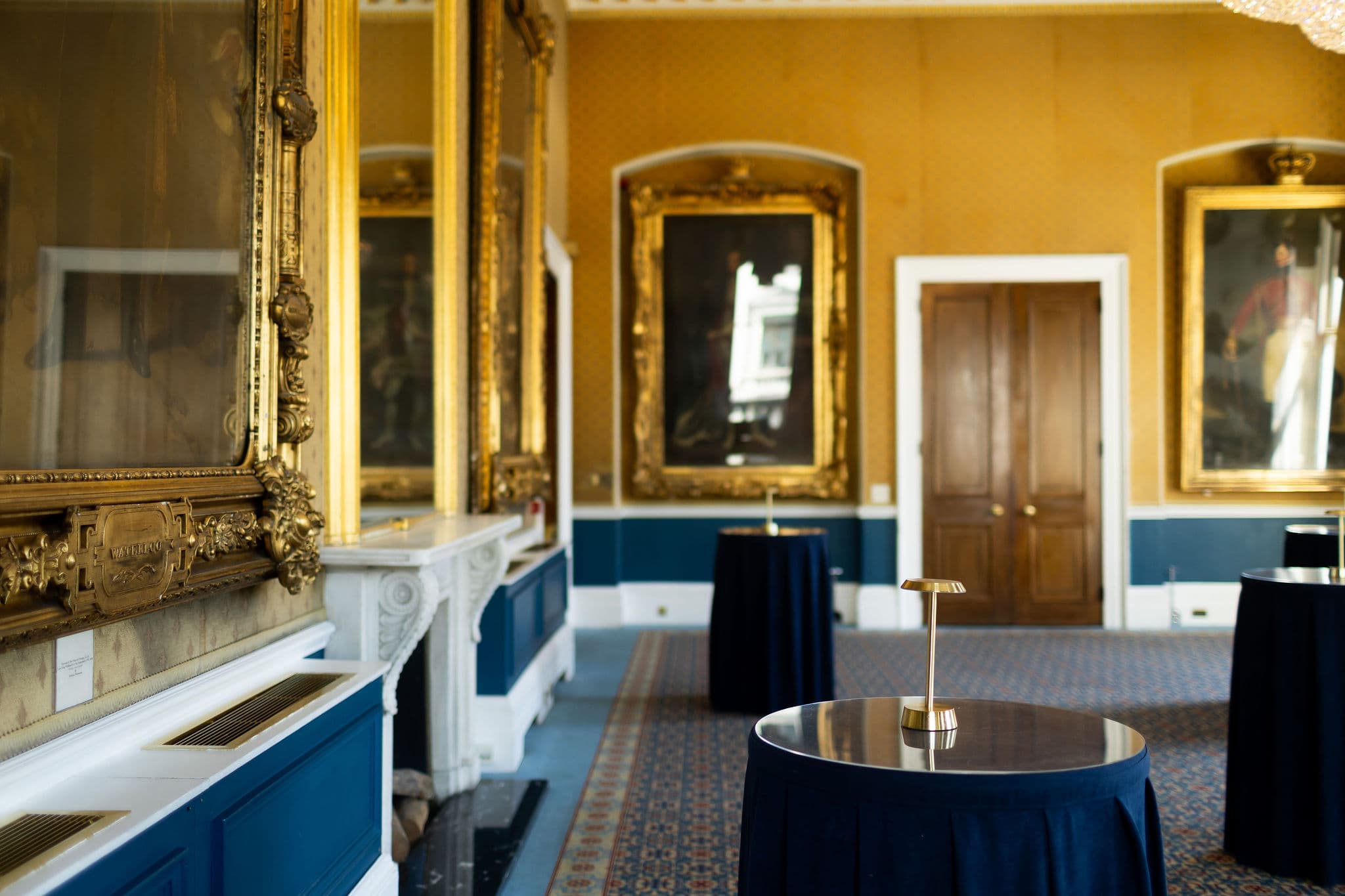 Navy-draped tables at 116 Pall Mall, a historic luxury venue for sophisticated cocktail receptions.